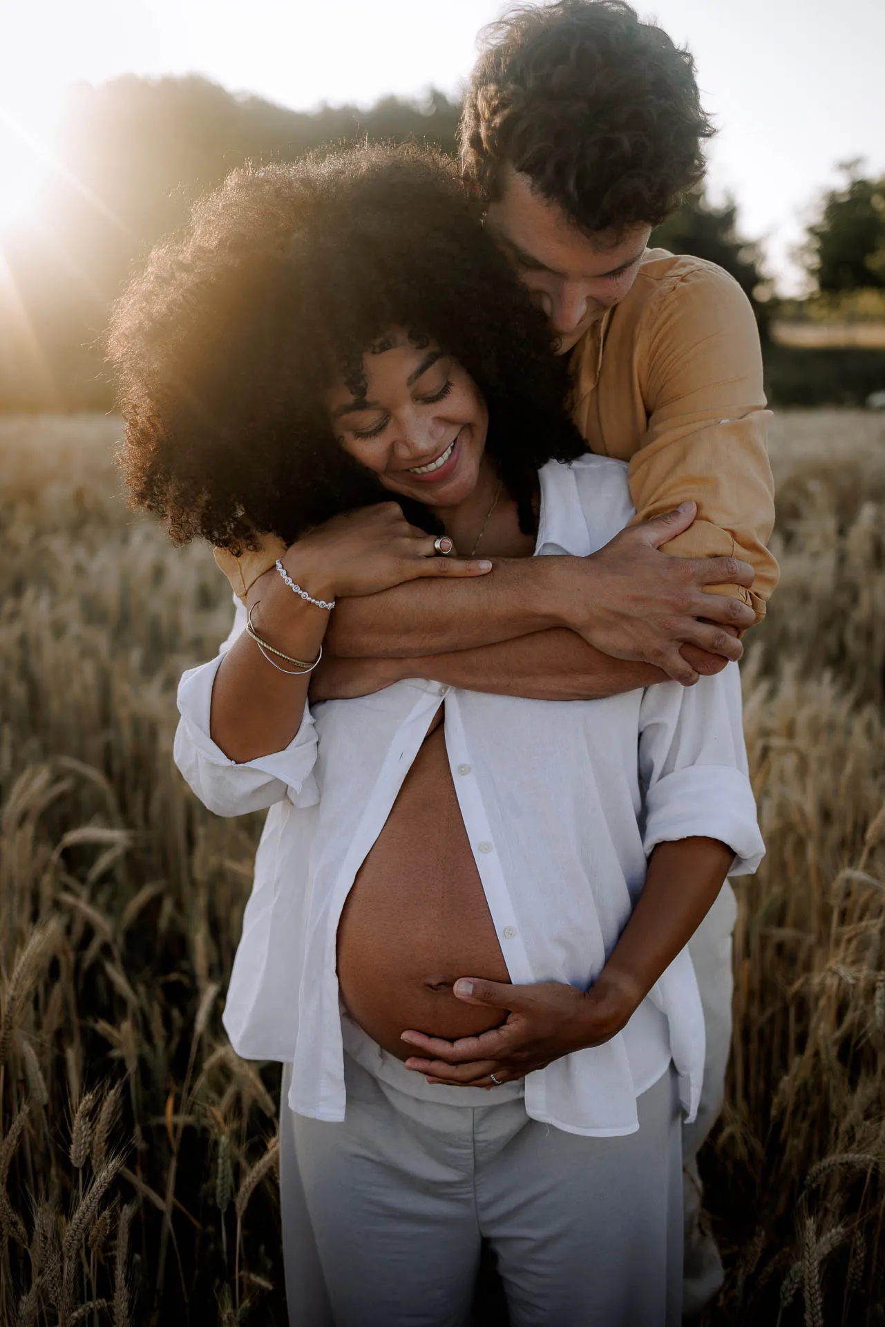 Pregnant woman in water at evening light Munich by Lena Dugnus