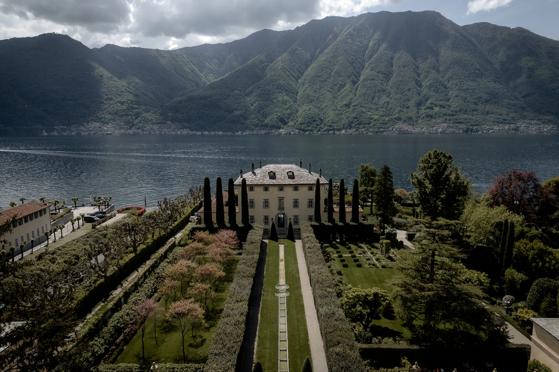 Villa Balbiano on Lake Como with mountains and Italian gardens from bird's eye view