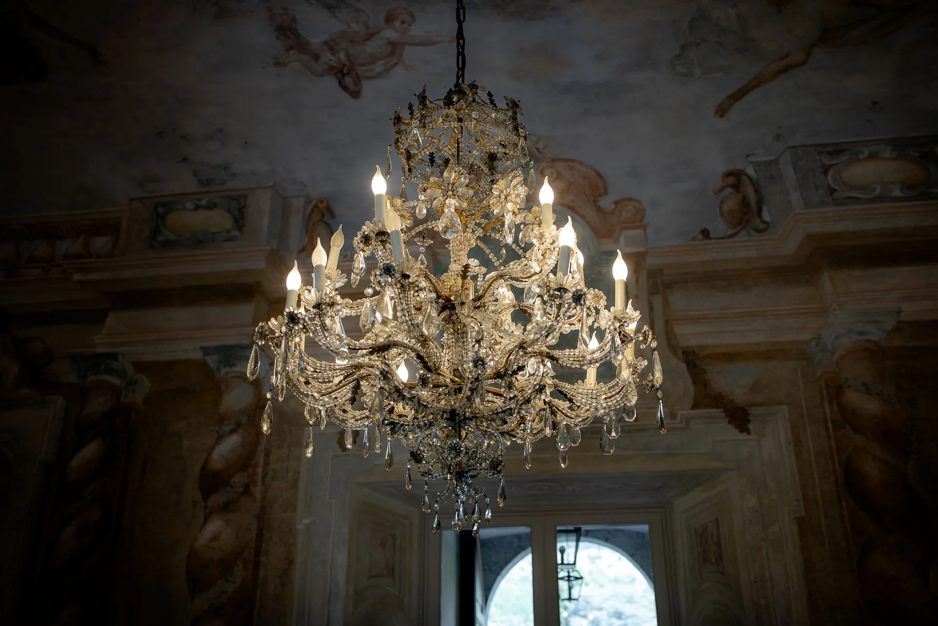 Magnificent crystal chandelier in historic Villa Balbiano with frescoed ceiling