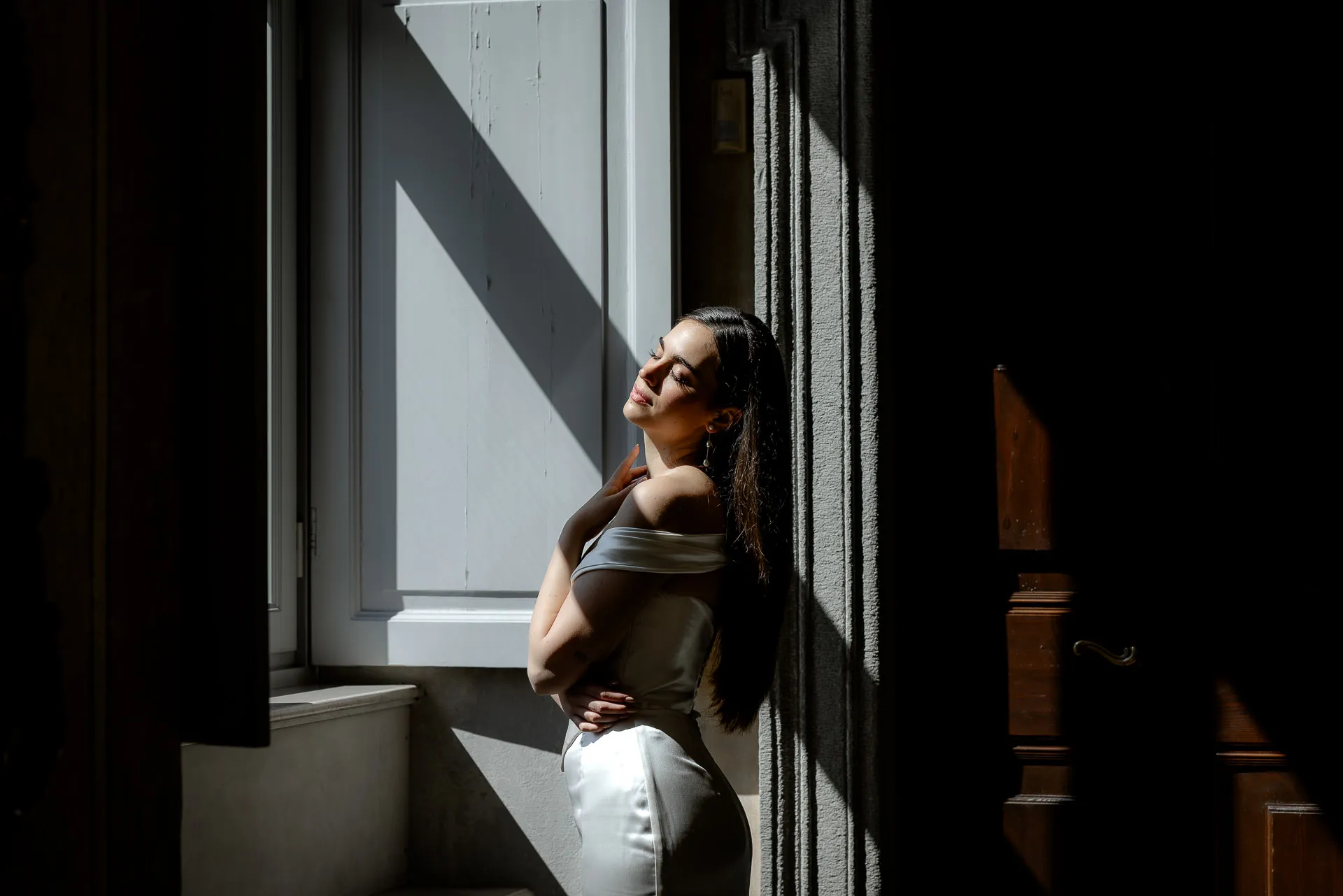 Romantic bridal portrait with natural window light in Italian villa