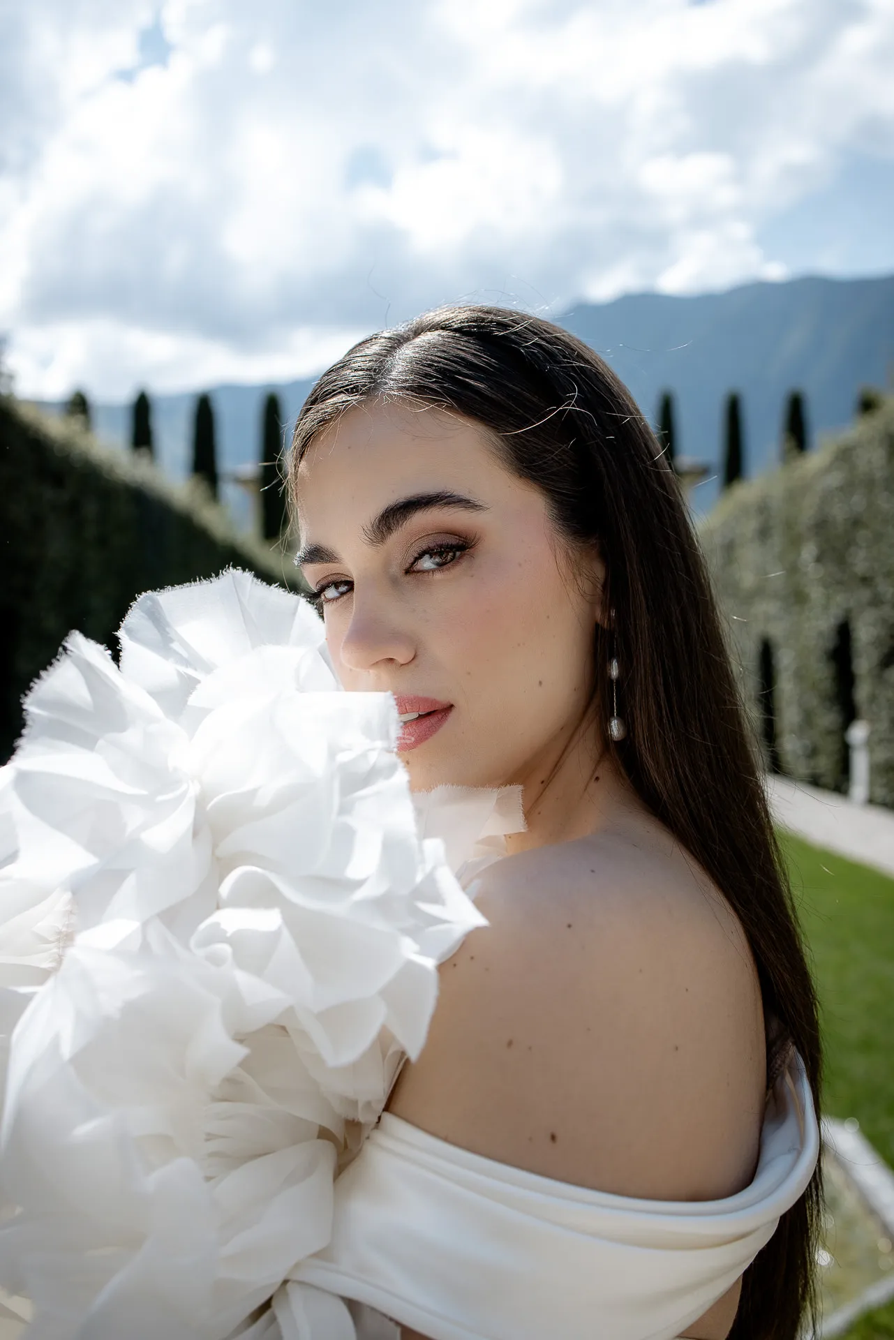 Close-up of bride with extravagant designer wedding dress at Lake Como