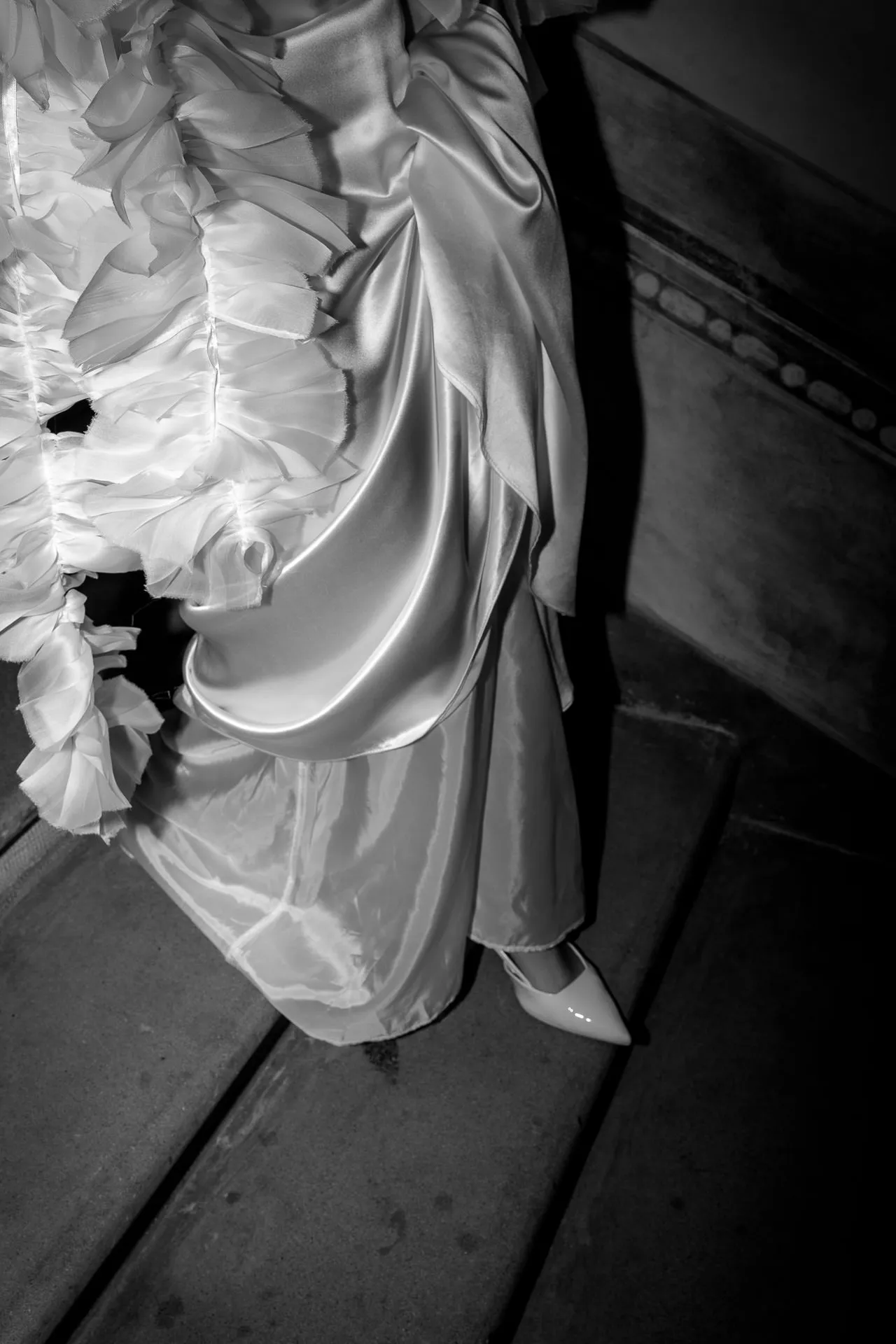 Detail shot of wedding dress with silk and ruffles black and white