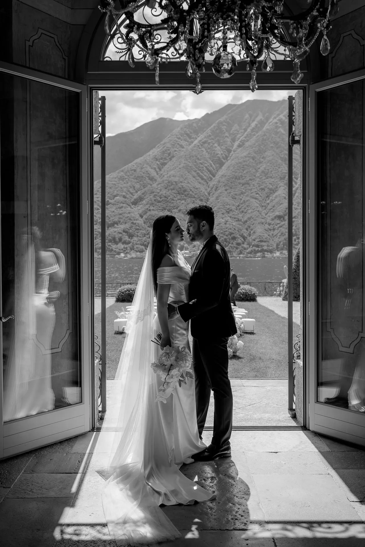 Wedding couple in Villa Balbiano doorway with Lake Como view black and white