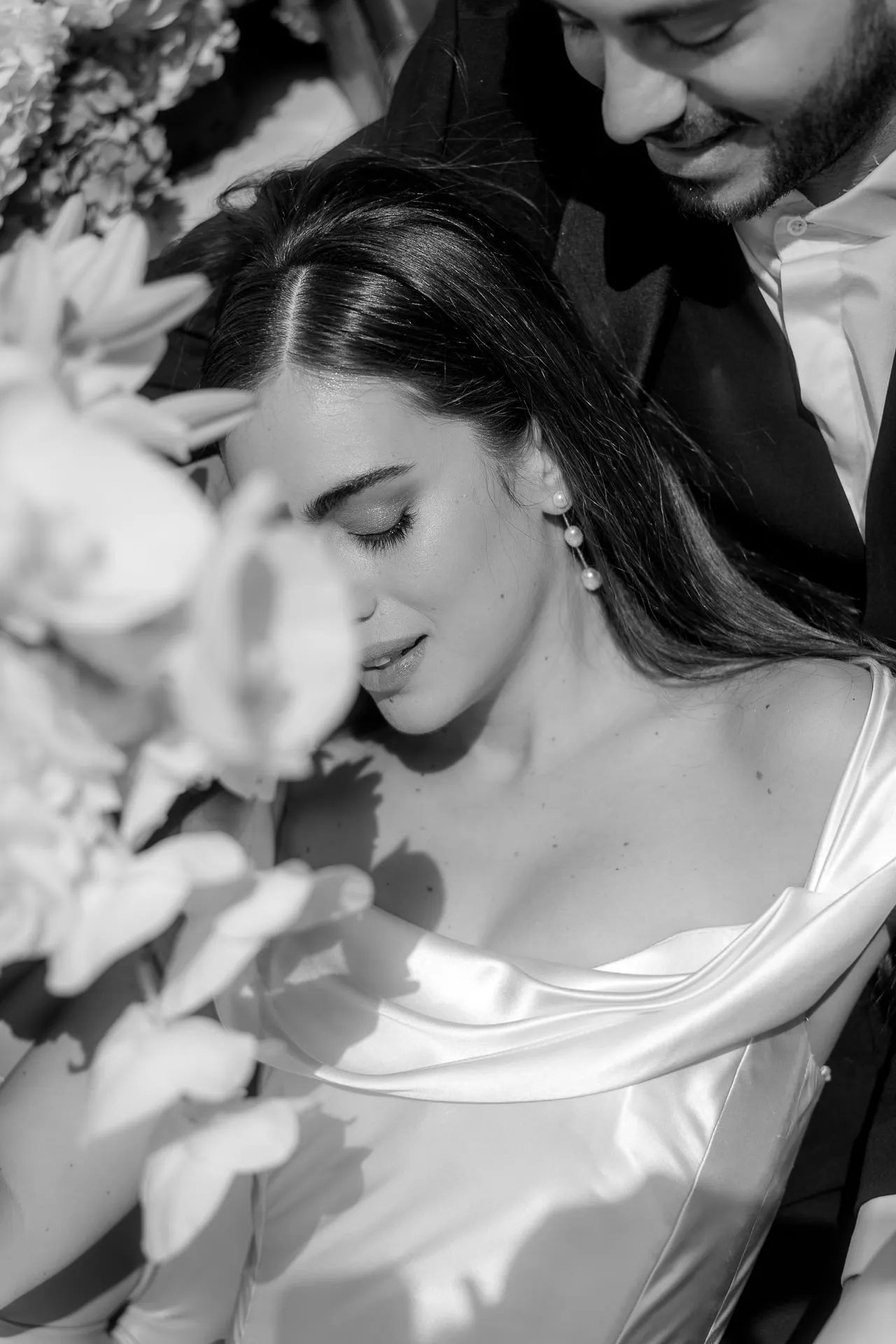 Intimate wedding couple moment on luxury boat at Lake Como black and white