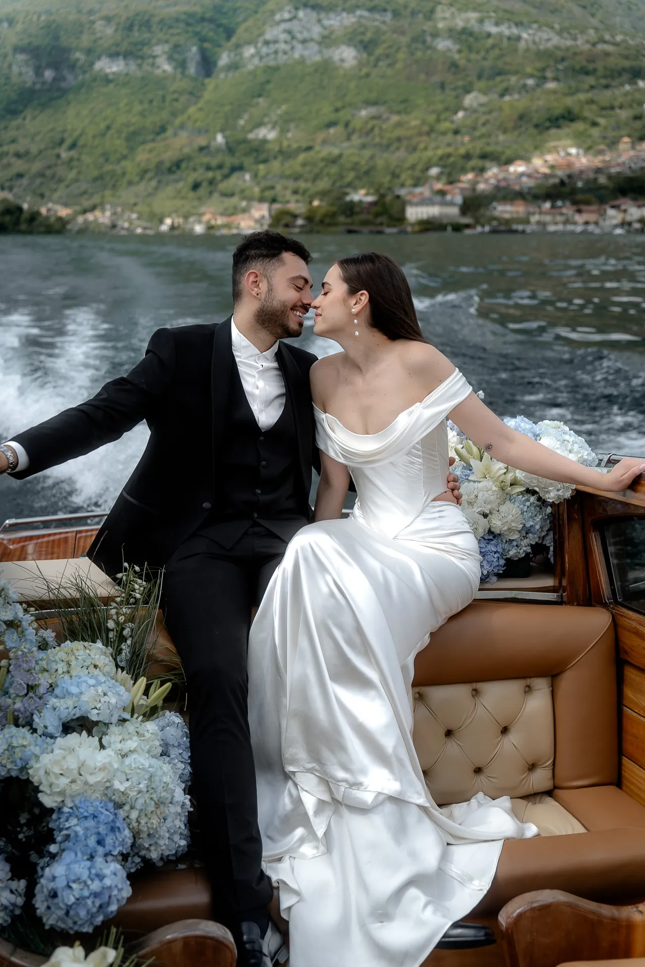Couple in love in Venetian motorboat on Lake Como