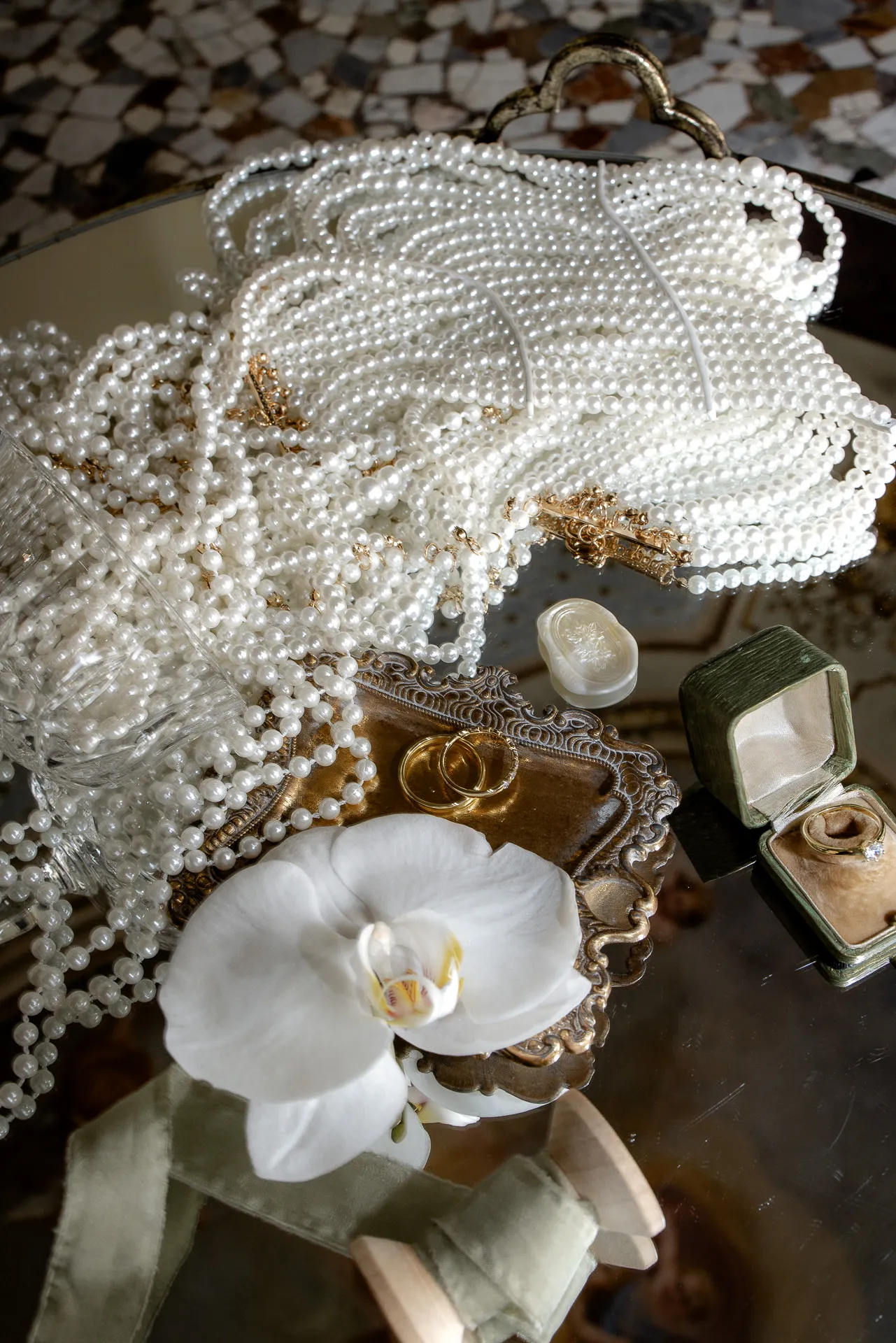 Luxurious wedding details pearl purse wedding rings and orchid decoration
