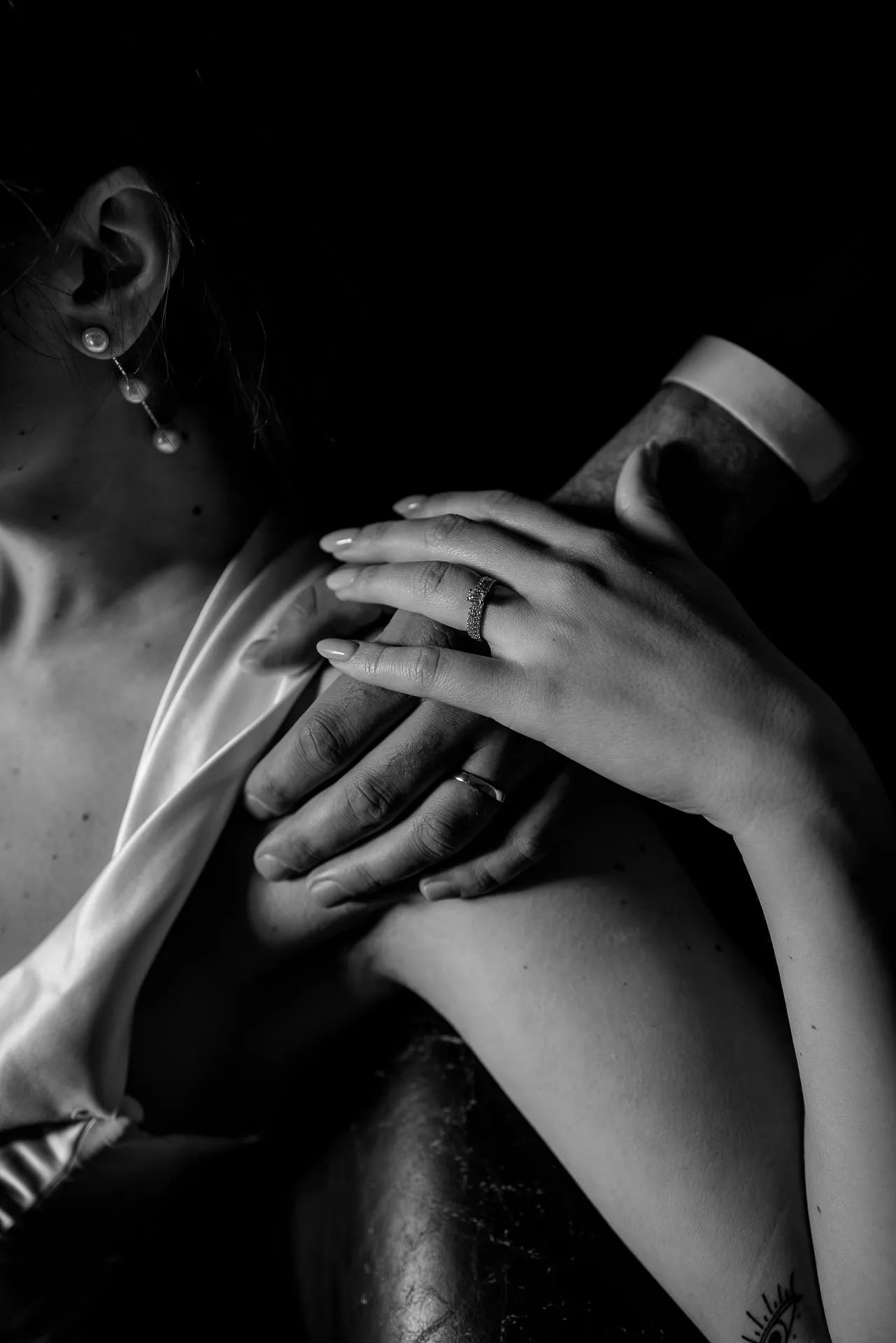 Artistic black and white detail wedding couple hands with wedding rings