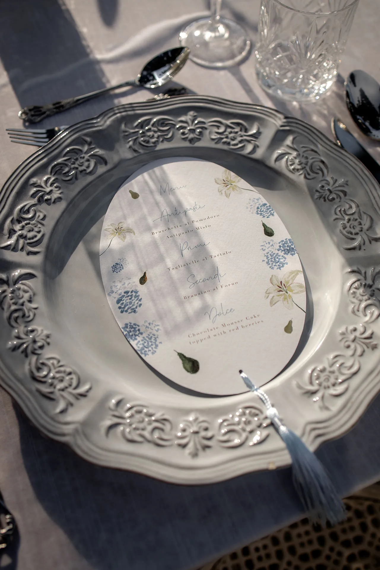 Elegant wedding stationery with menu card on ornamental plate at Villa Balbiano