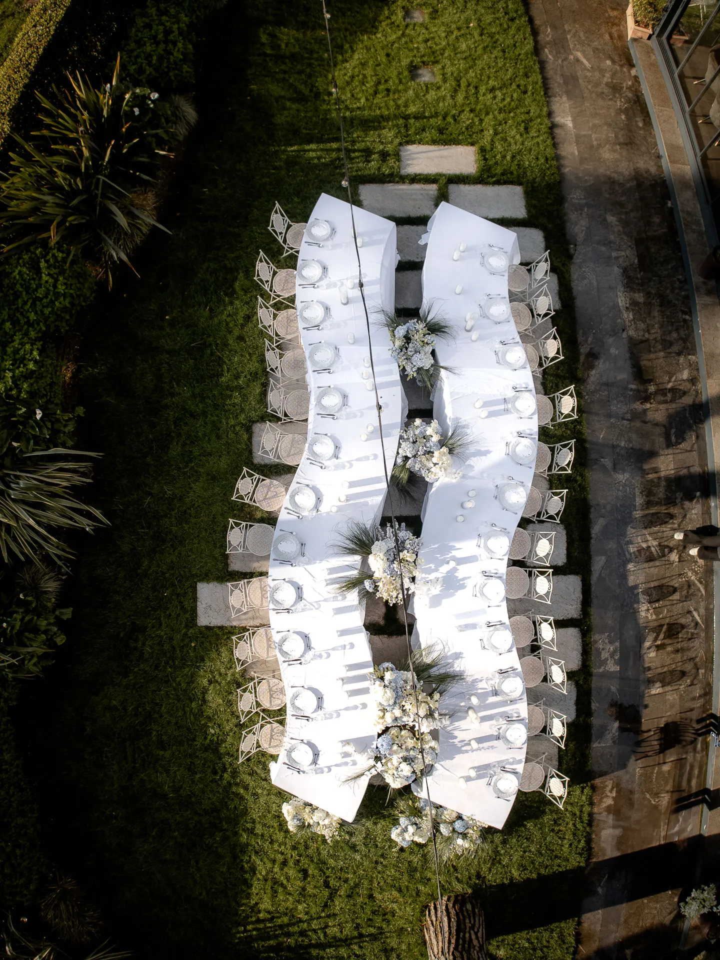 Drone shot of elegantly set wedding table at Villa Balbiano with floral arrangements