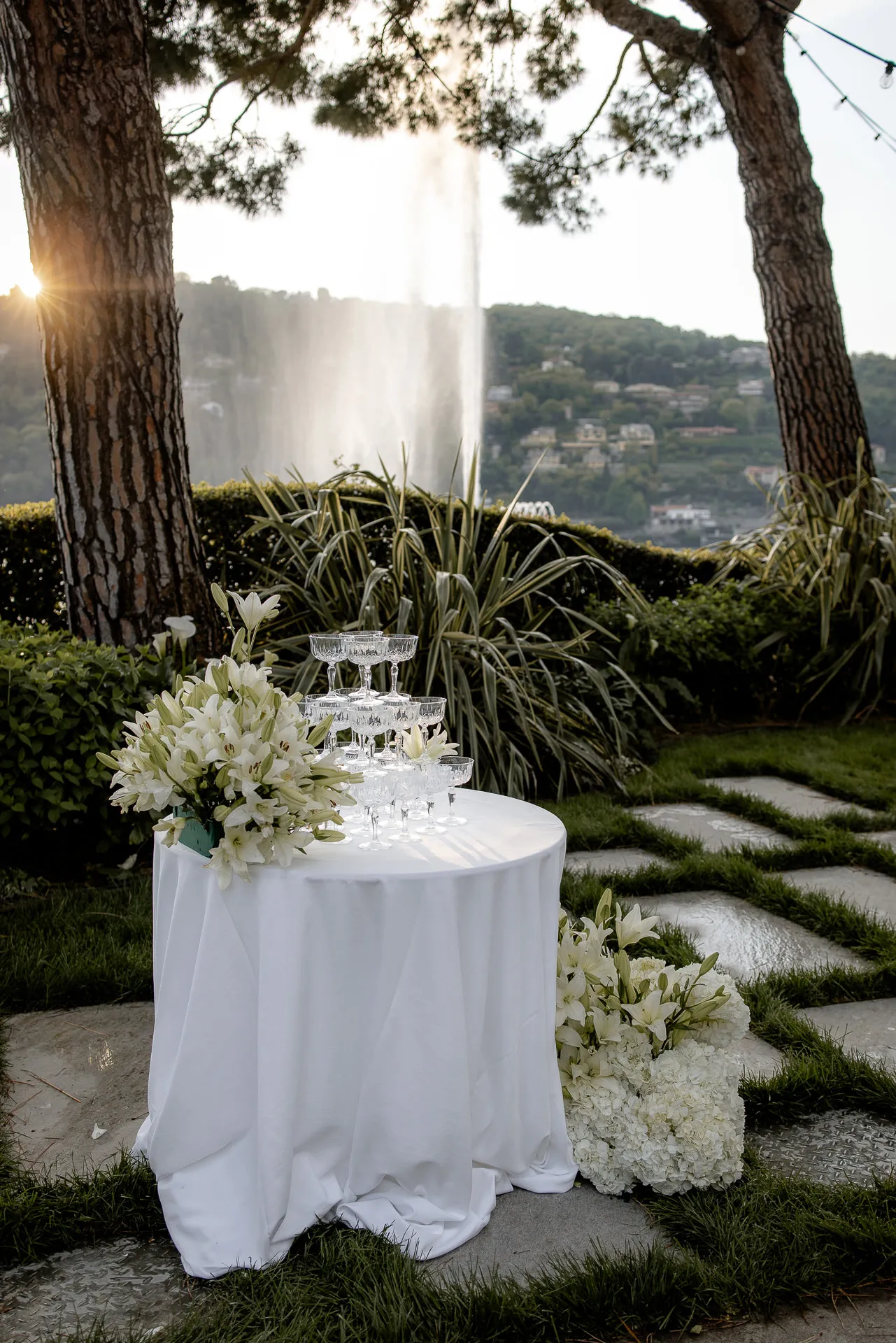 Champagne tower and white floral decoration at sunset Lake Como wedding