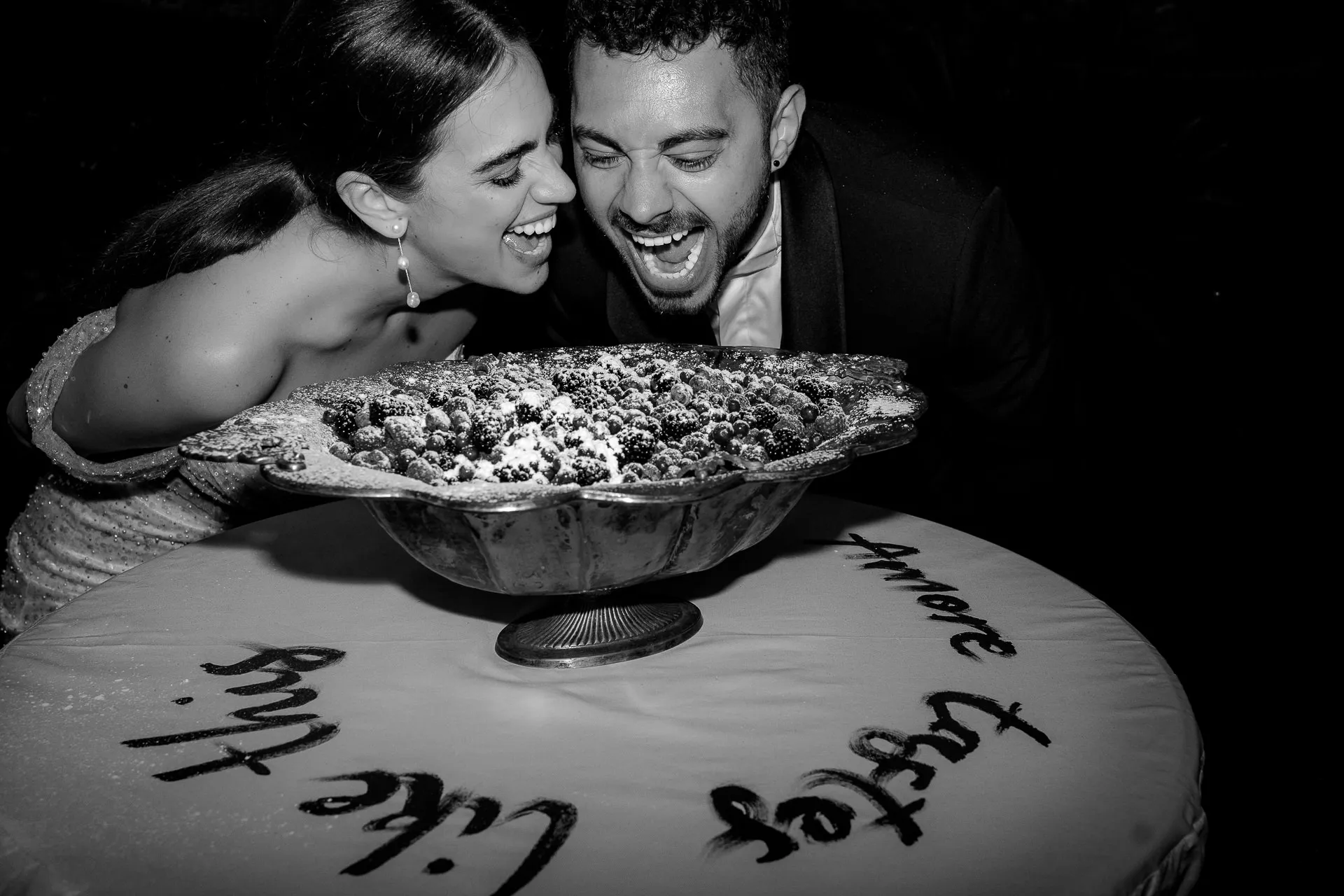 Happy wedding couple at cake cutting black and white at Villa Balbiano