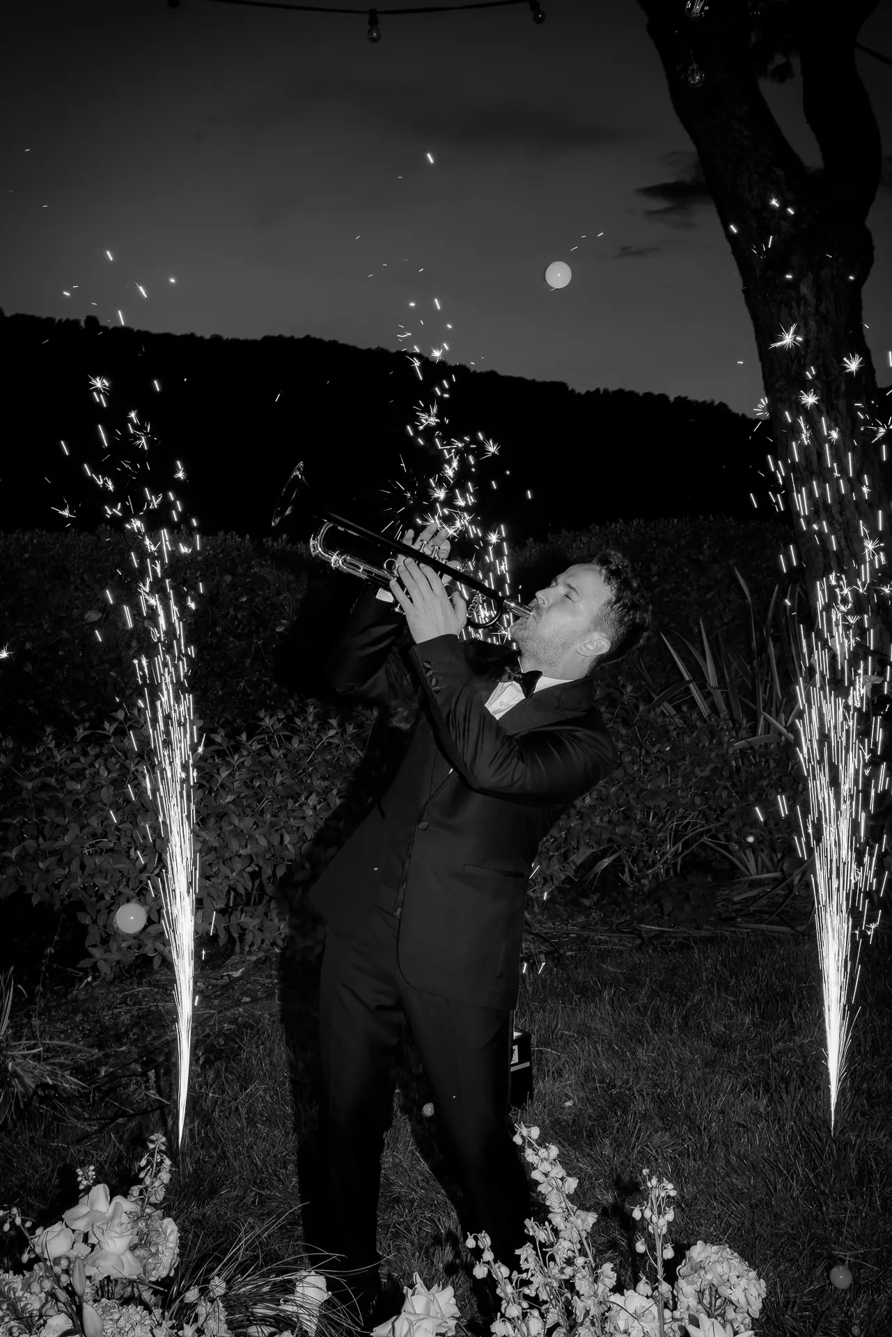 Groom drinking champagne with sparkler fountains black and white at Lake Como