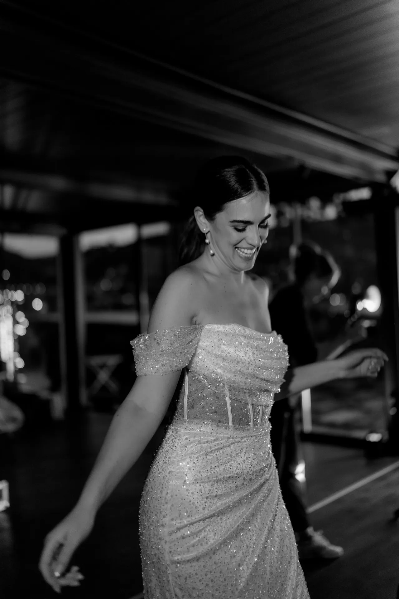 Radiant bride dancing at wedding reception in sparkling dress black and white