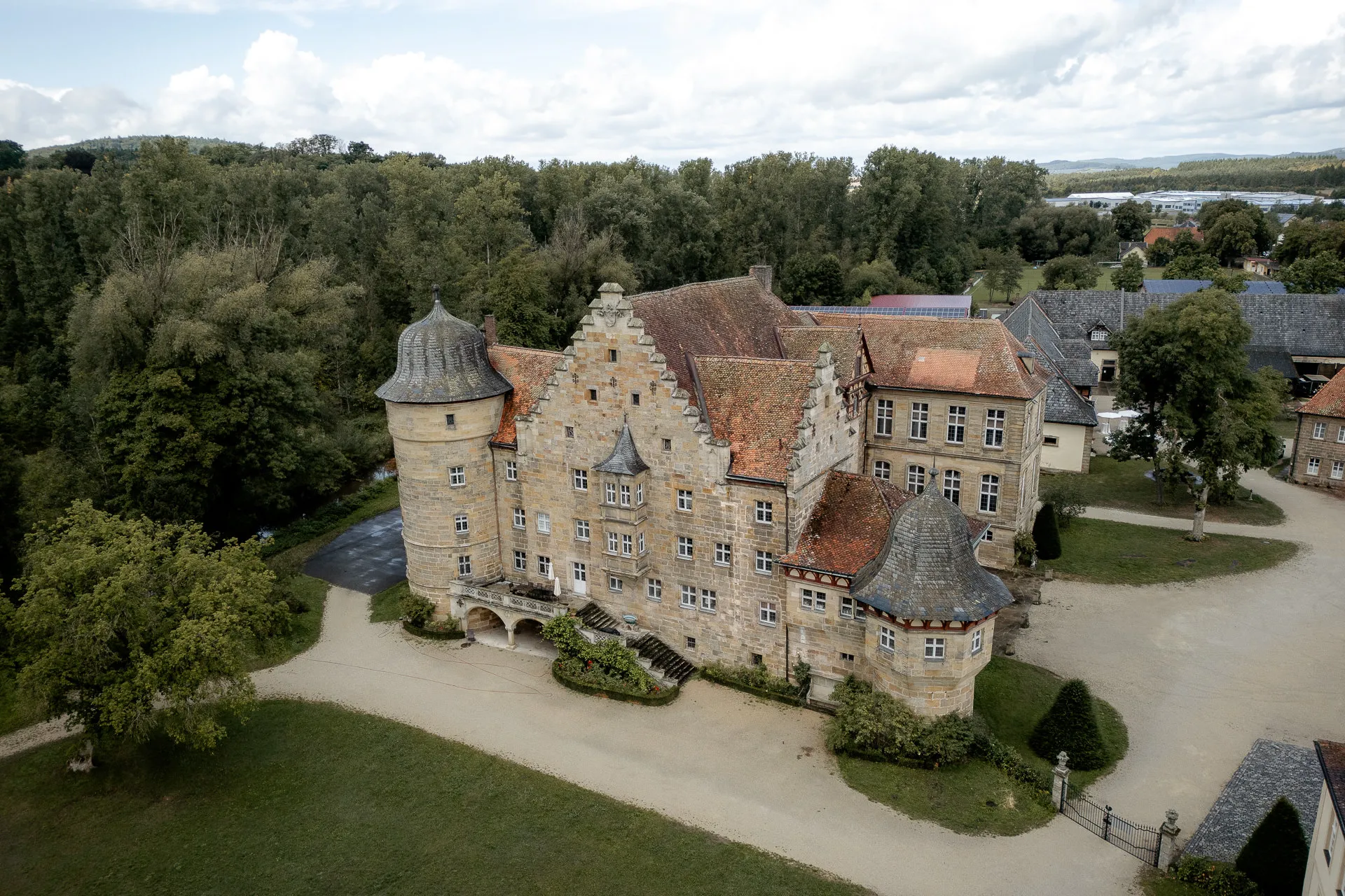 Aerial view of Schloss Eyrichshof with historic architecture and green park grounds