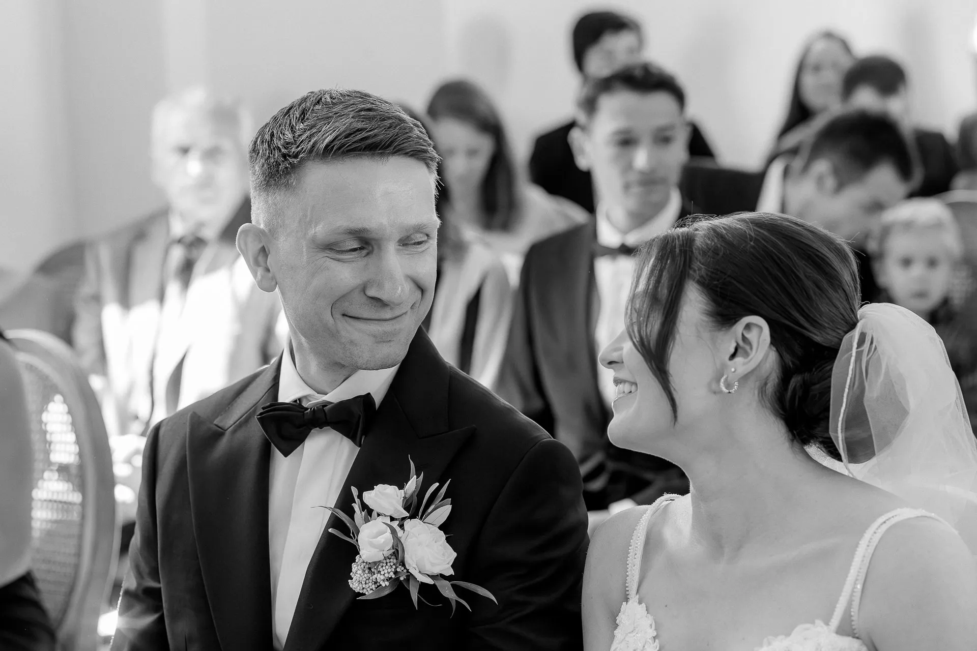 Emotional moment between bride and groom during wedding ceremony at Schloss Eyrichshof black and white