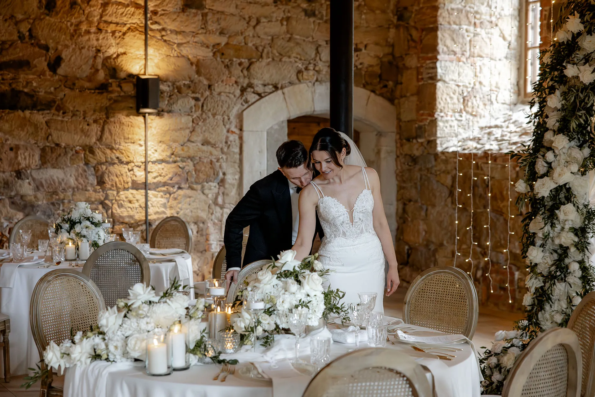 Romantic bride and groom at festively decorated bride's table with candles at Schloss Eyrichshof