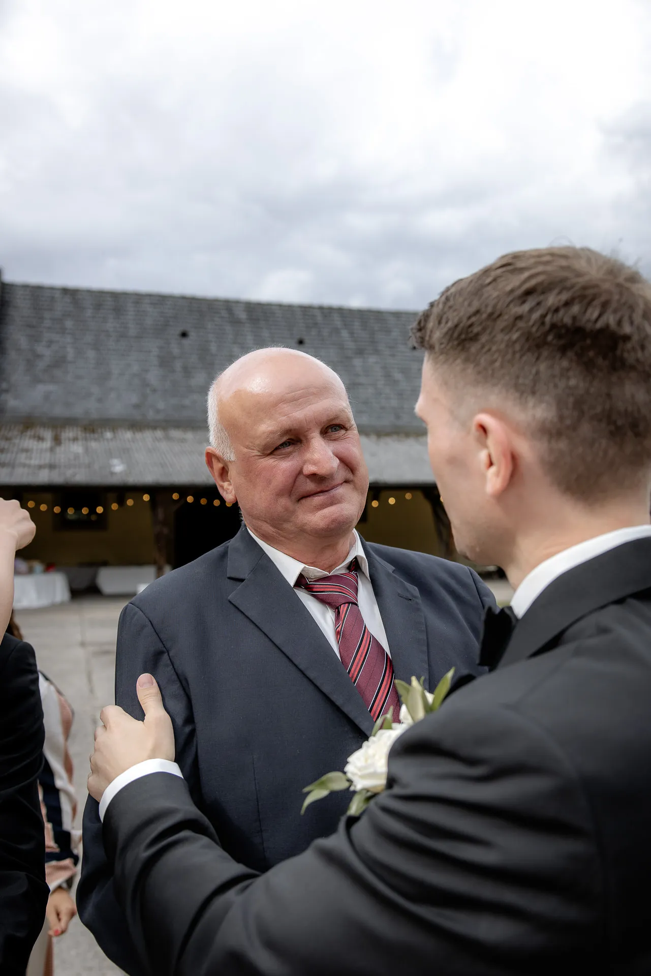 Emotional moment between groom and wedding guest at Schloss Eyrichshof