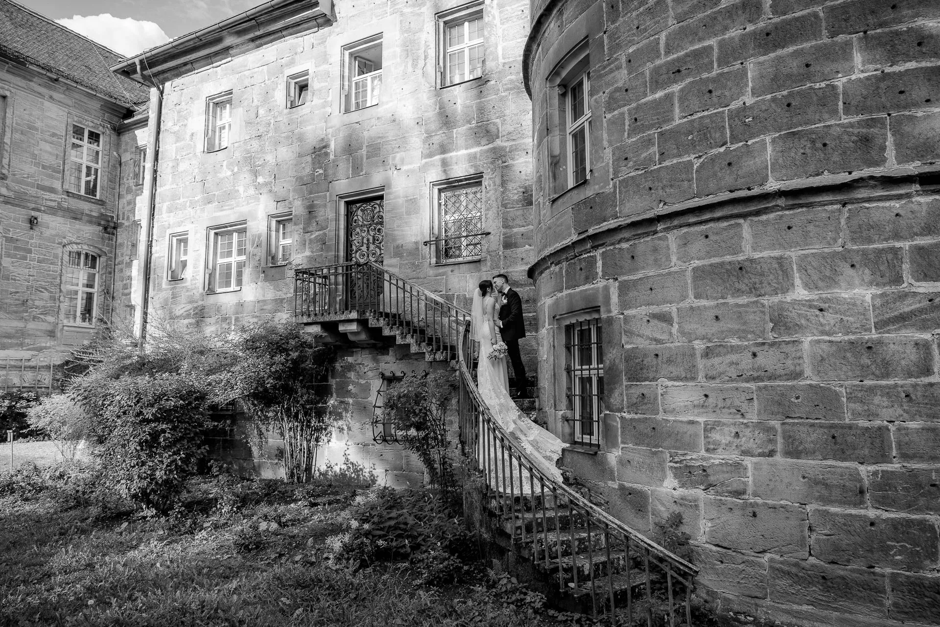 Bride and groom at historic castle stairs Eyrichshof in black and white wedding photography