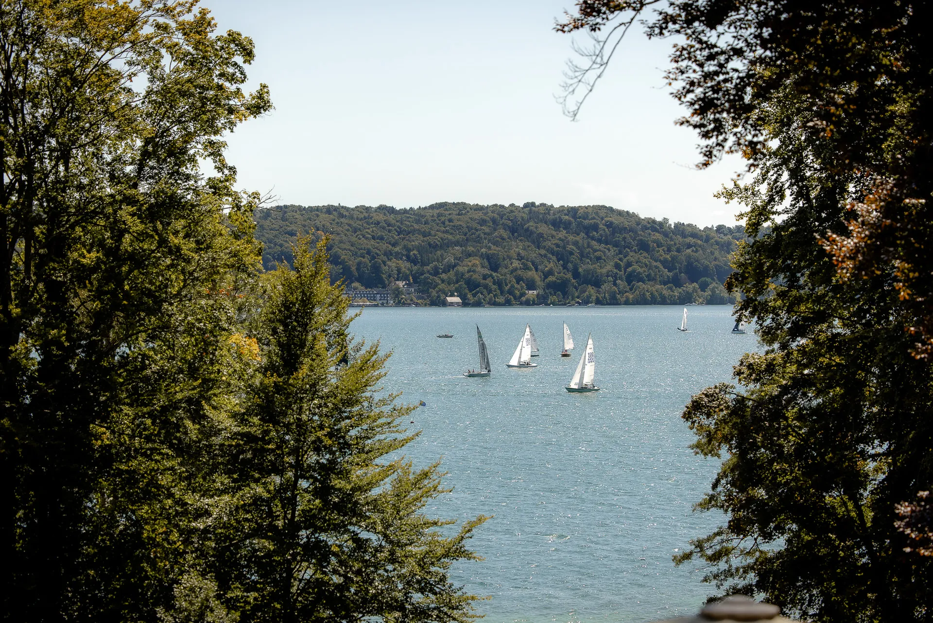 Picturesque view through trees of Lake Starnberg with sailboats at La Villa wedding