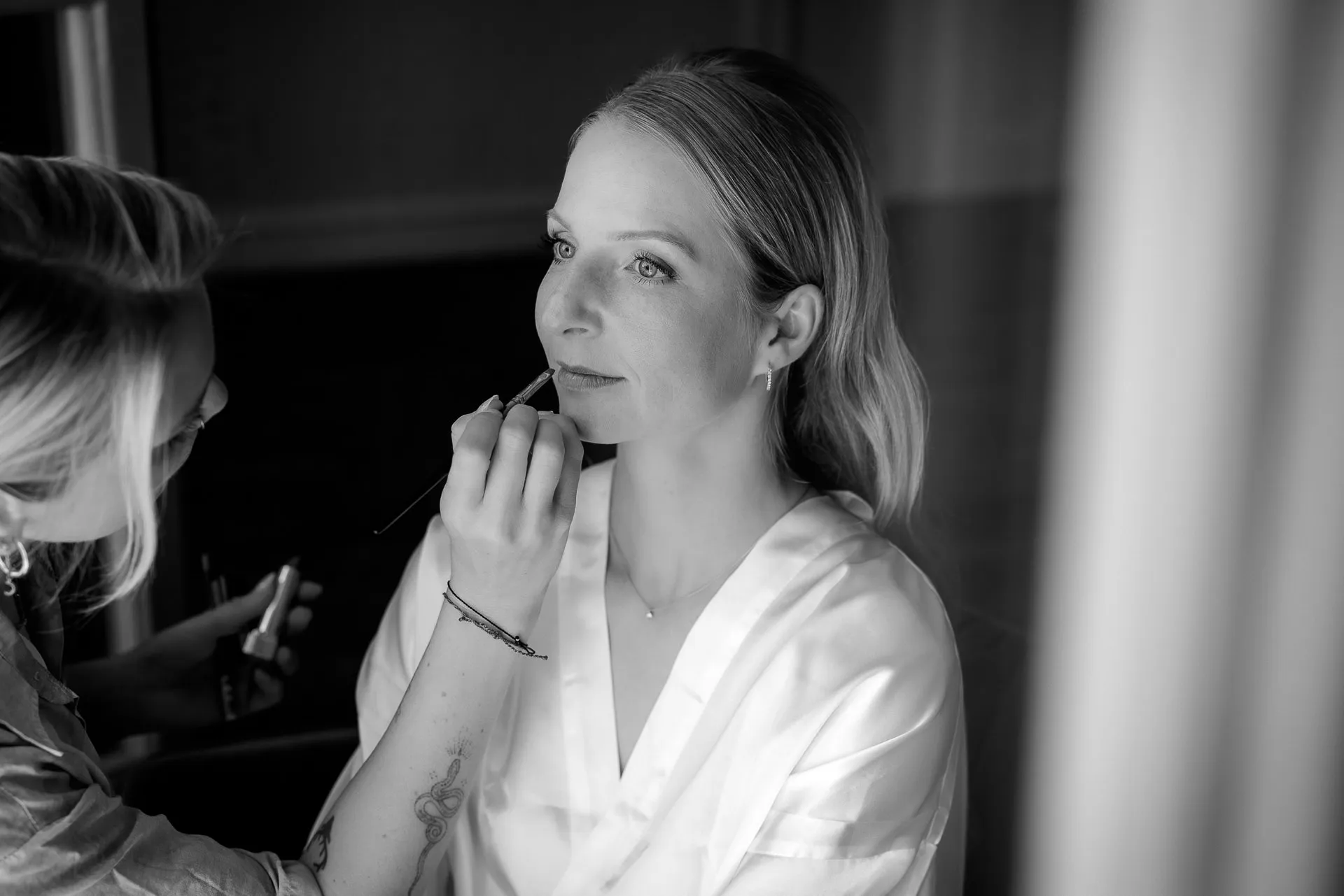 Bride make-up preparation black and white at Lake Starnberg wedding