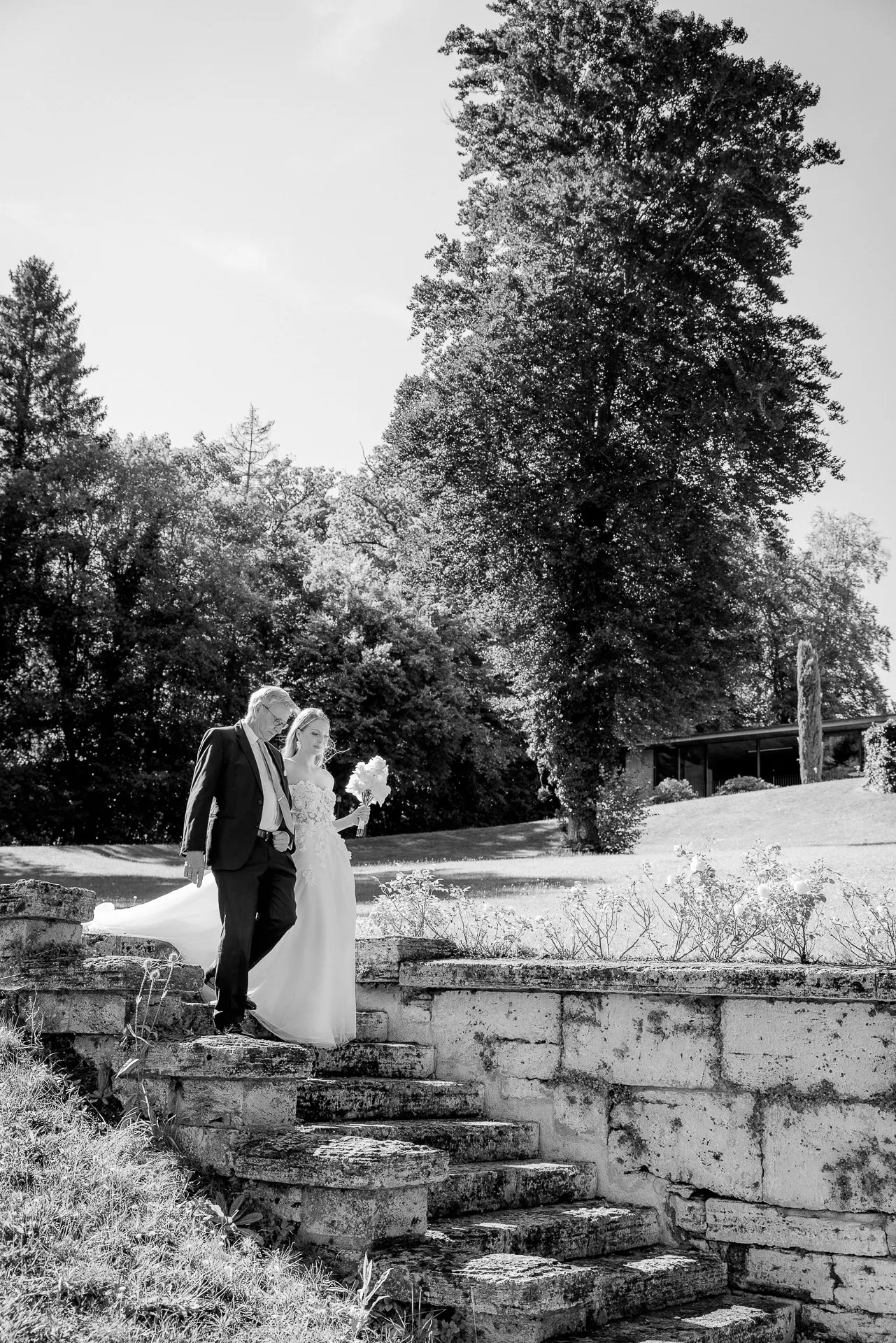 Wedding couple on stone staircase black and white at La Villa lakeside wedding
