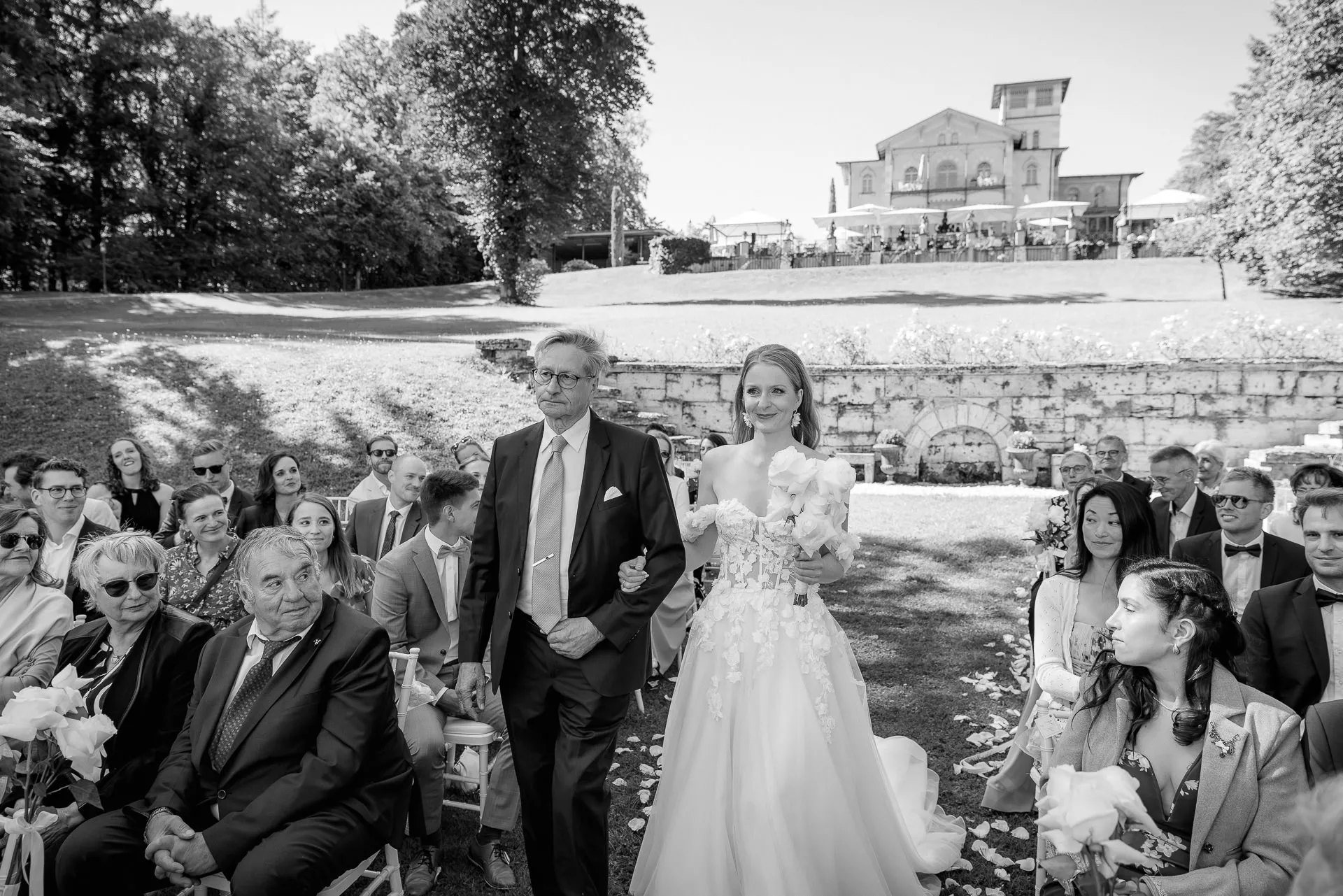Bride walking with father to altar at outdoor ceremony on Lake Starnberg