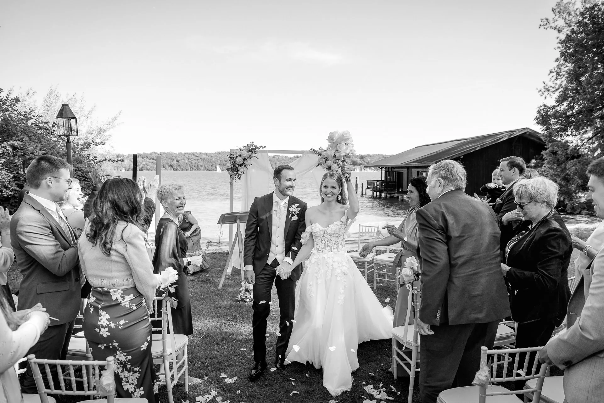 Couple walking down aisle after ceremony with celebrating guests