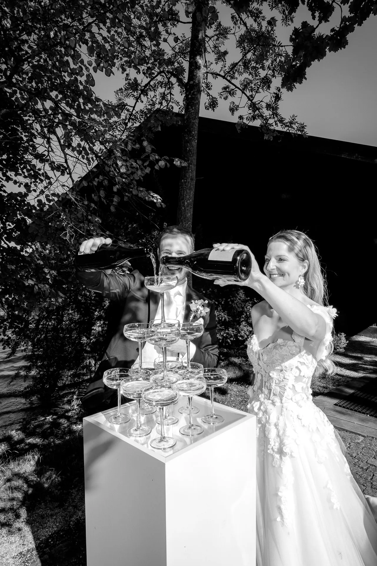 Couple pouring champagne tower at La Villa wedding celebration