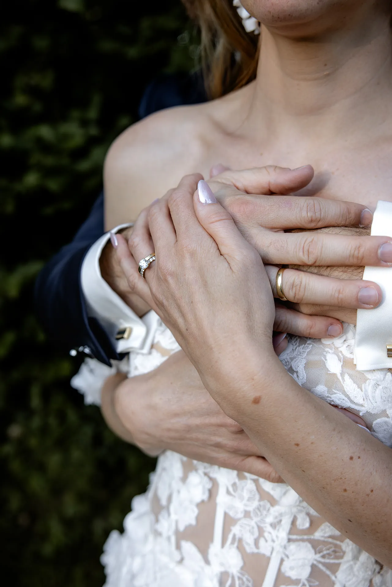 Detail shot wedding rings on couple's hands