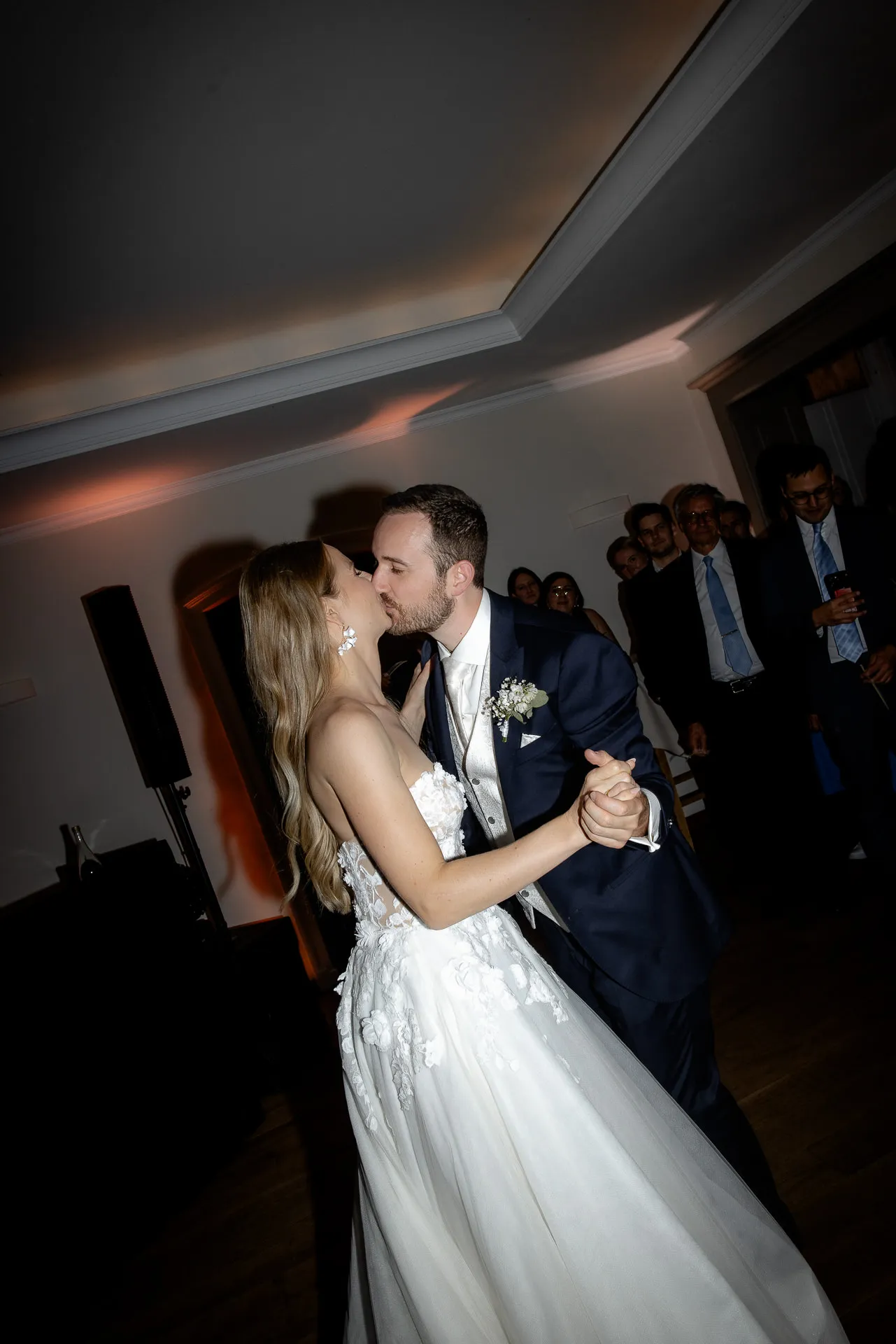 First dance of couple with guests in background at La Villa
