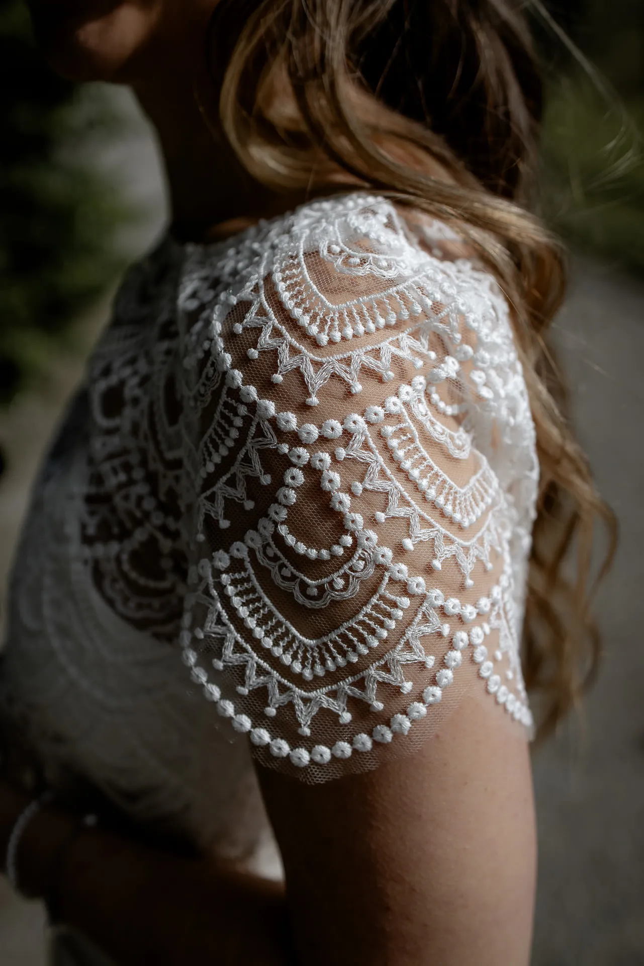 Wedding dress detail with lace sleeve and pearls – elegant wedding photography
