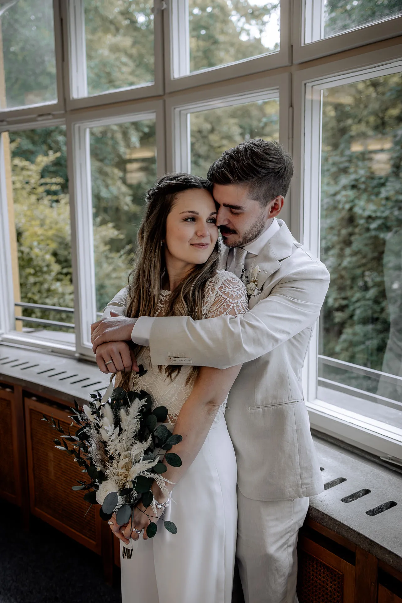 Romantic couple portrait by the window at Standesamt Munich