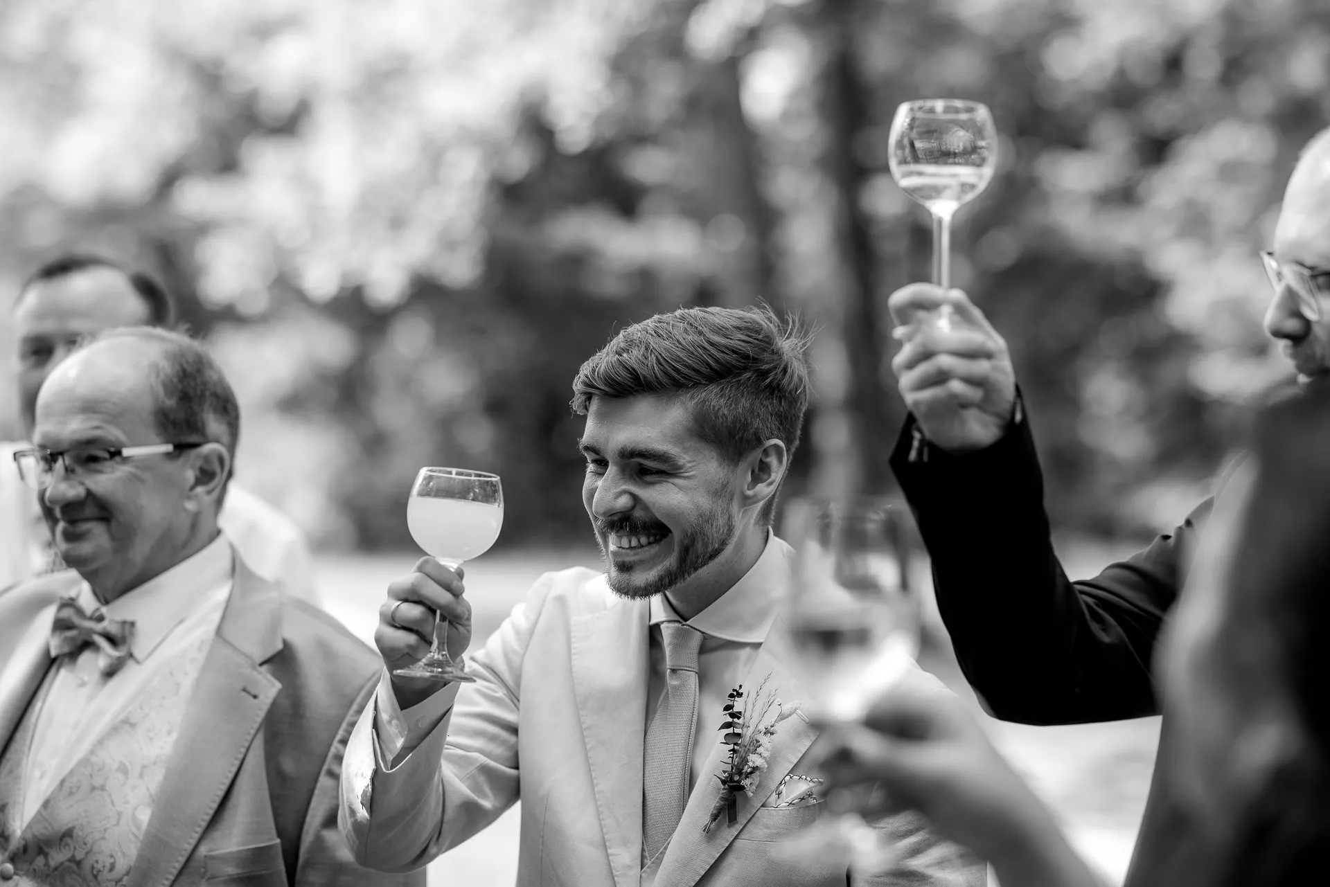 Groom toasting – wedding celebration in black and white