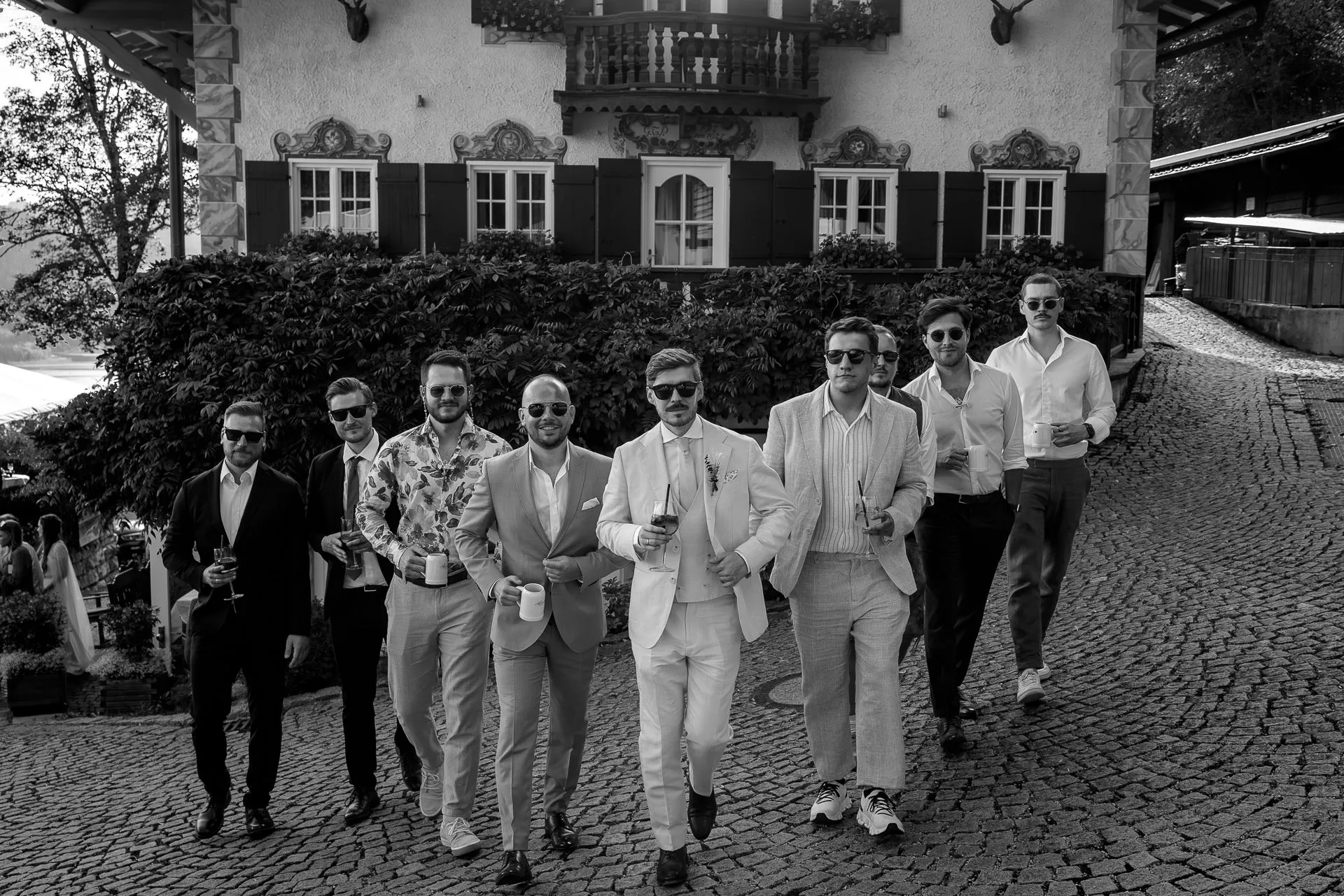 Groom and groomsmen in front of Leeberghof Tegernsee – stylish wedding photography in black and white
