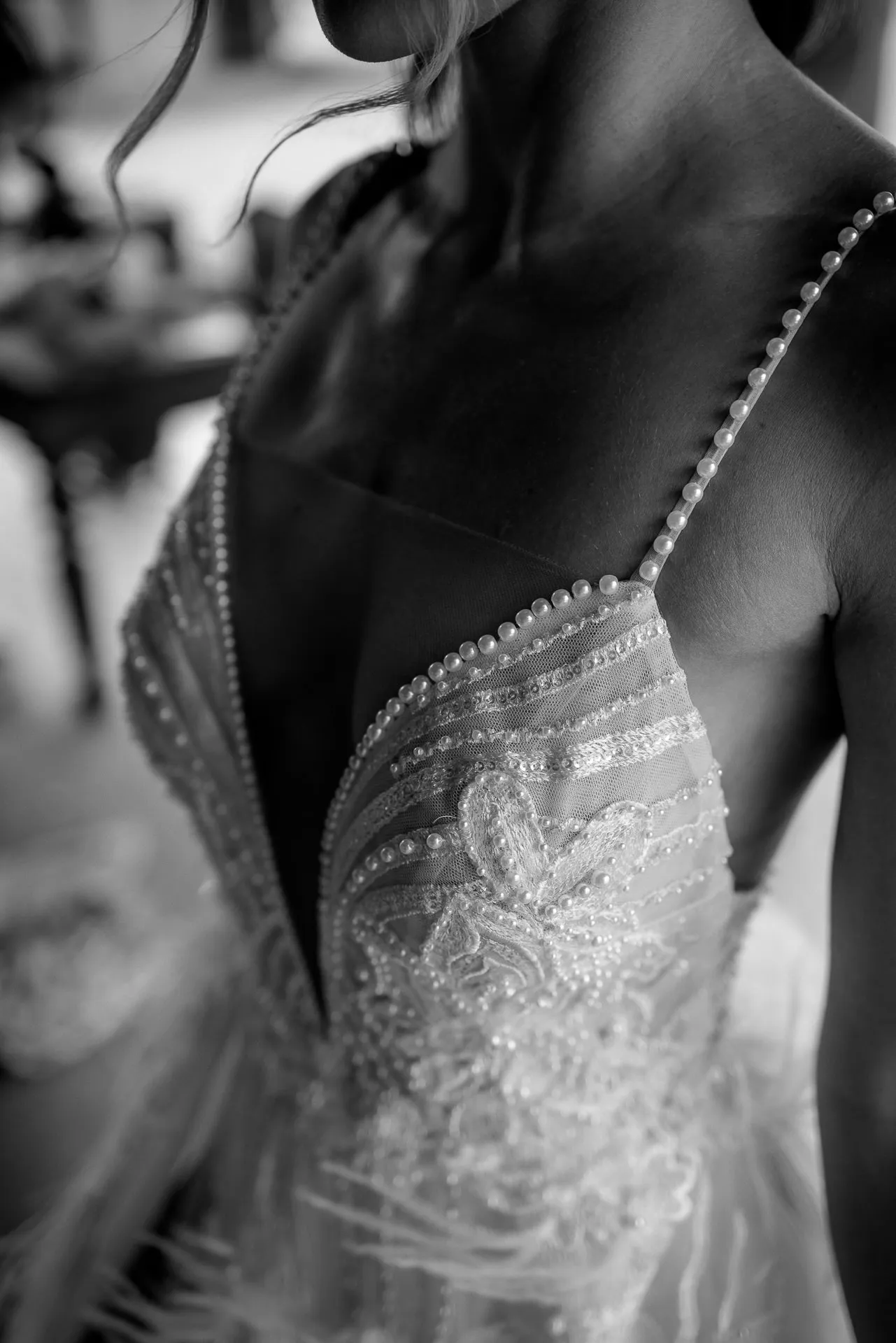Detail shot of pearl-embellished wedding dress in black and white during getting ready