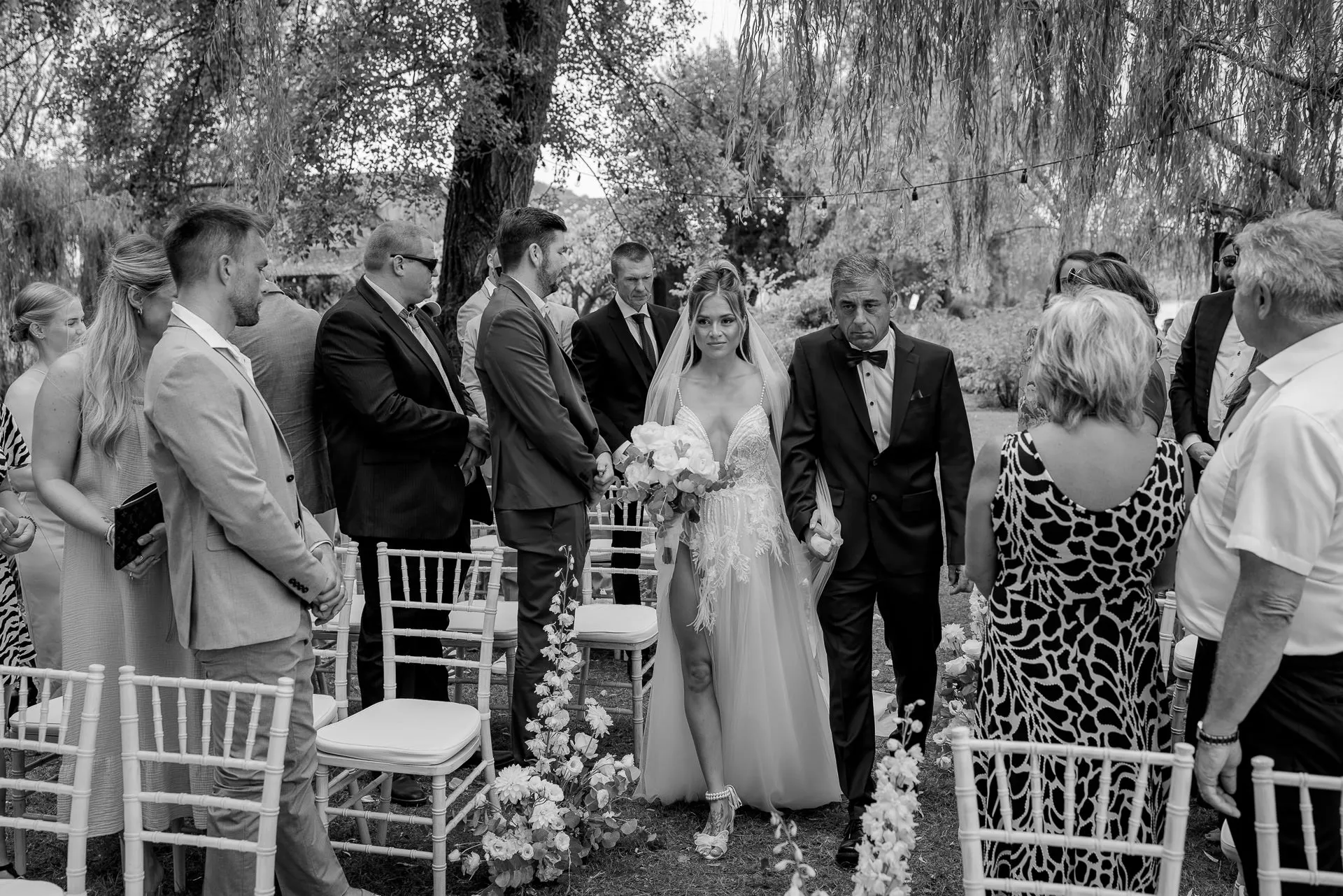 Bride walking down the aisle with her father during ceremony in Italy