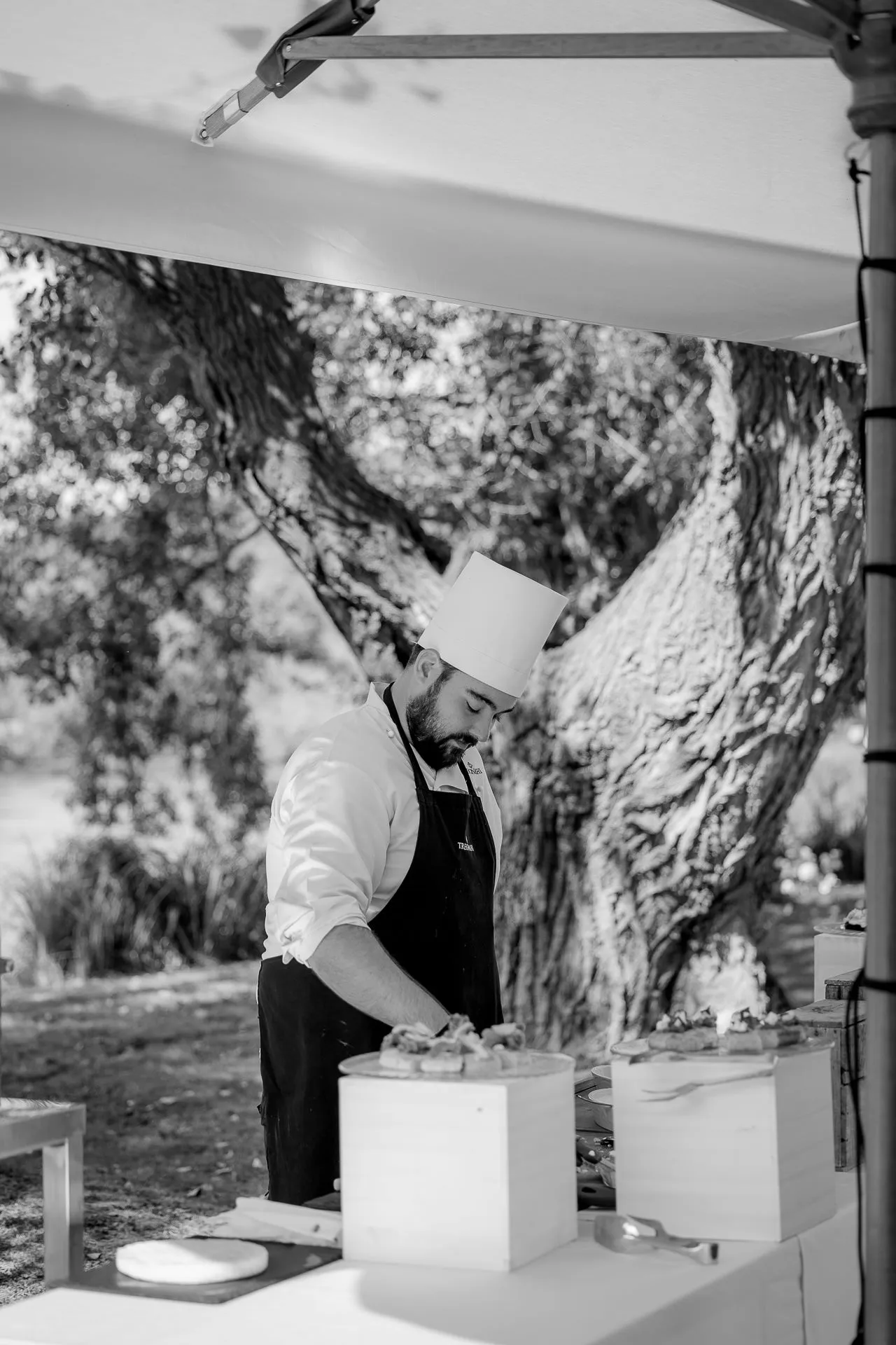 Chef preparing fresh dishes at outdoor Italian wedding reception
