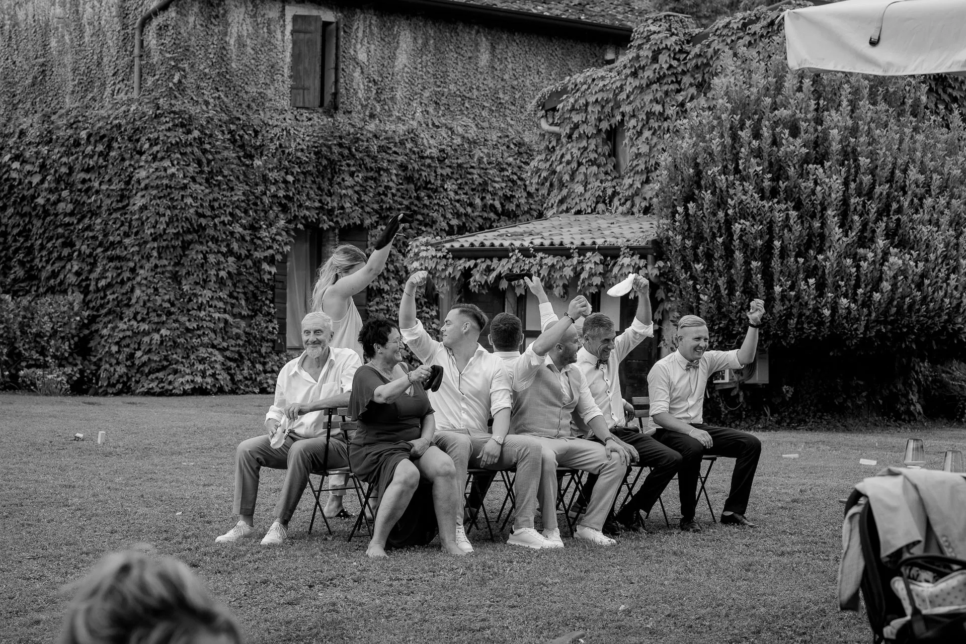 Wedding guests enthusiastically playing group game at Italian celebration