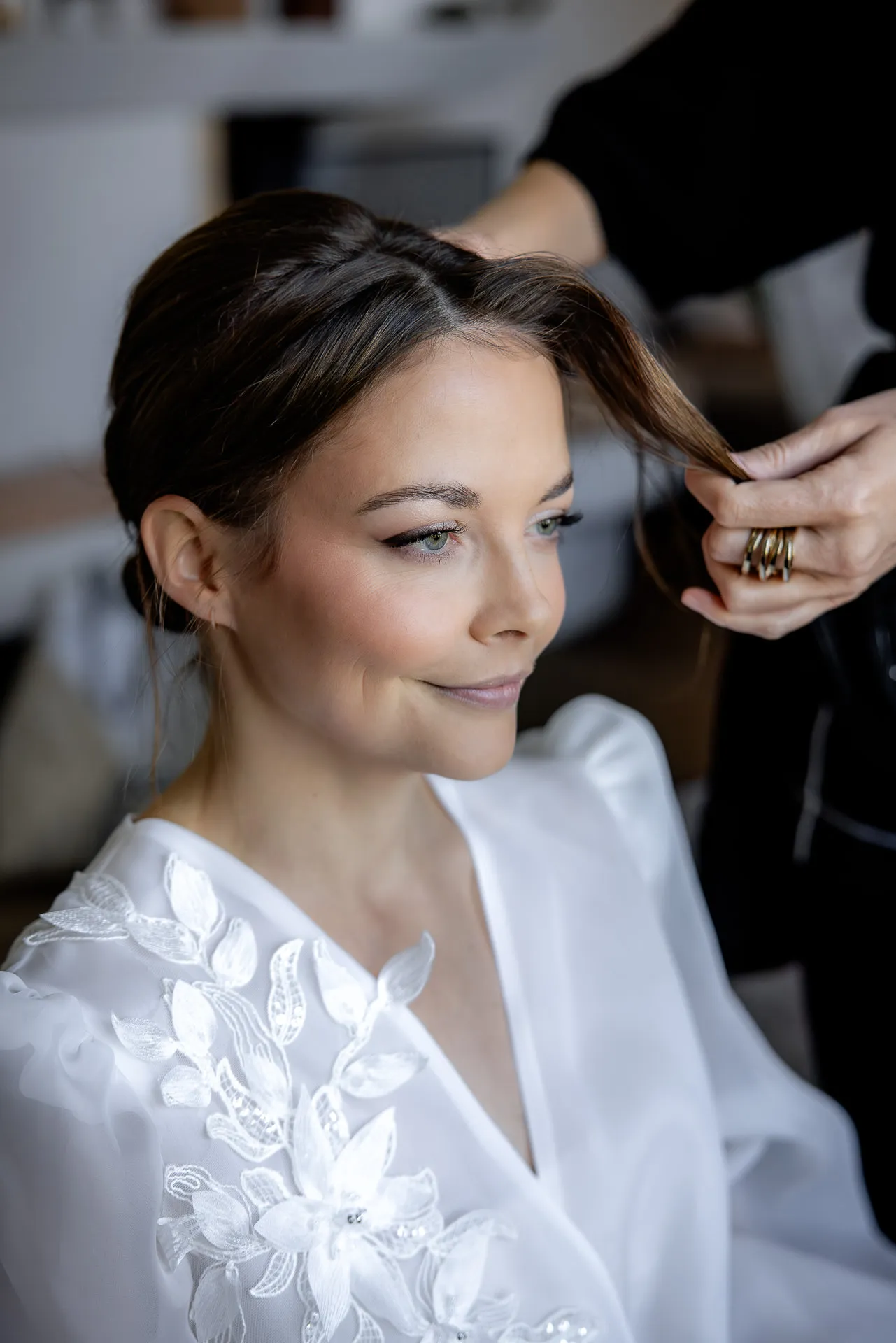 Bride during wedding preparation with hairstylist at Gut Sonnenhausen