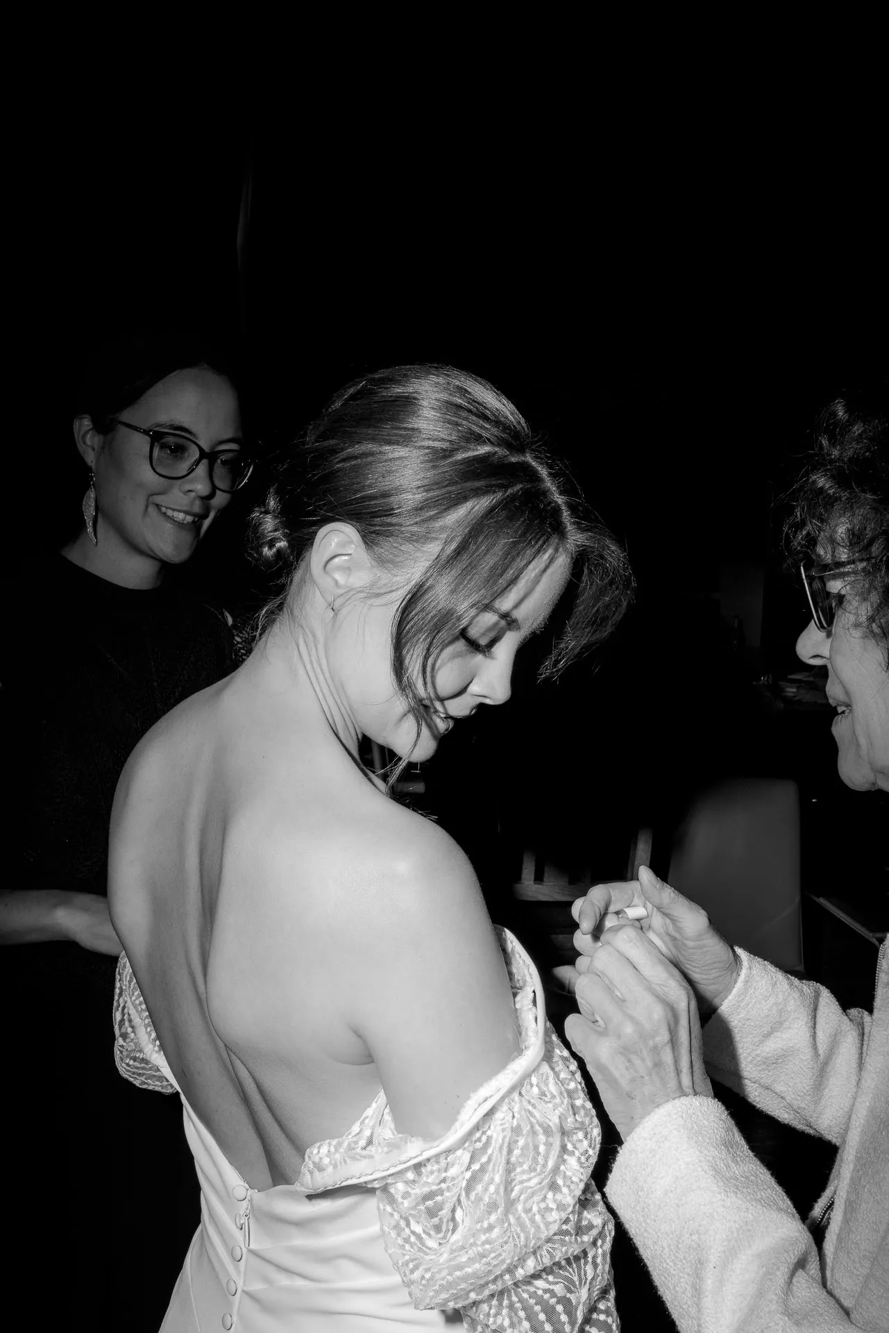 Bride being helped putting on wedding dress at Gut Sonnenhausen wedding