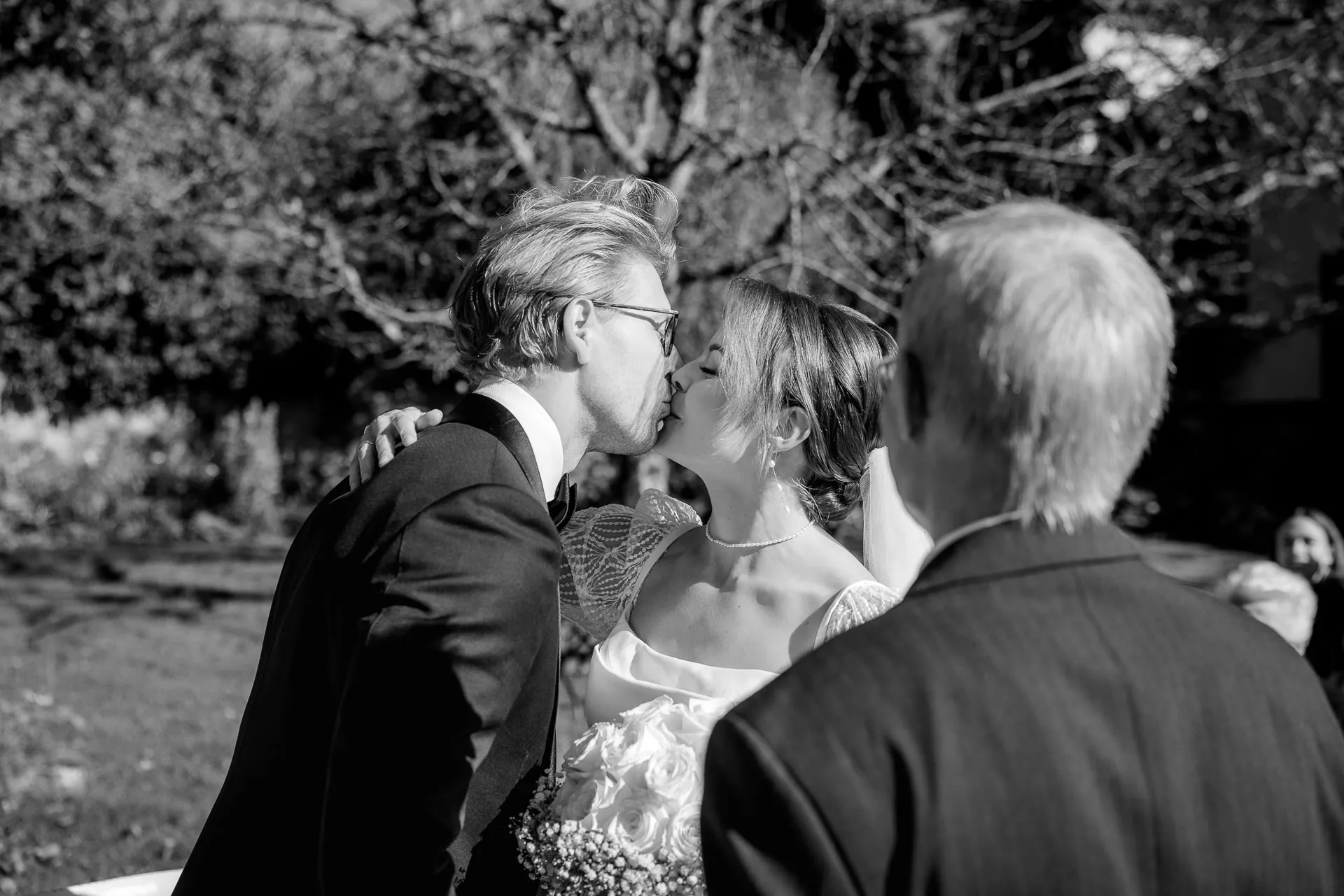 Bride and groom wedding kiss at ceremony in black and white at Gut Sonnenhausen