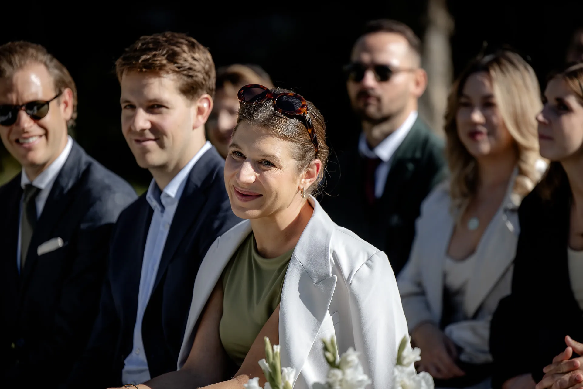 Smiling wedding guest at ceremony at Gut Sonnenhausen
