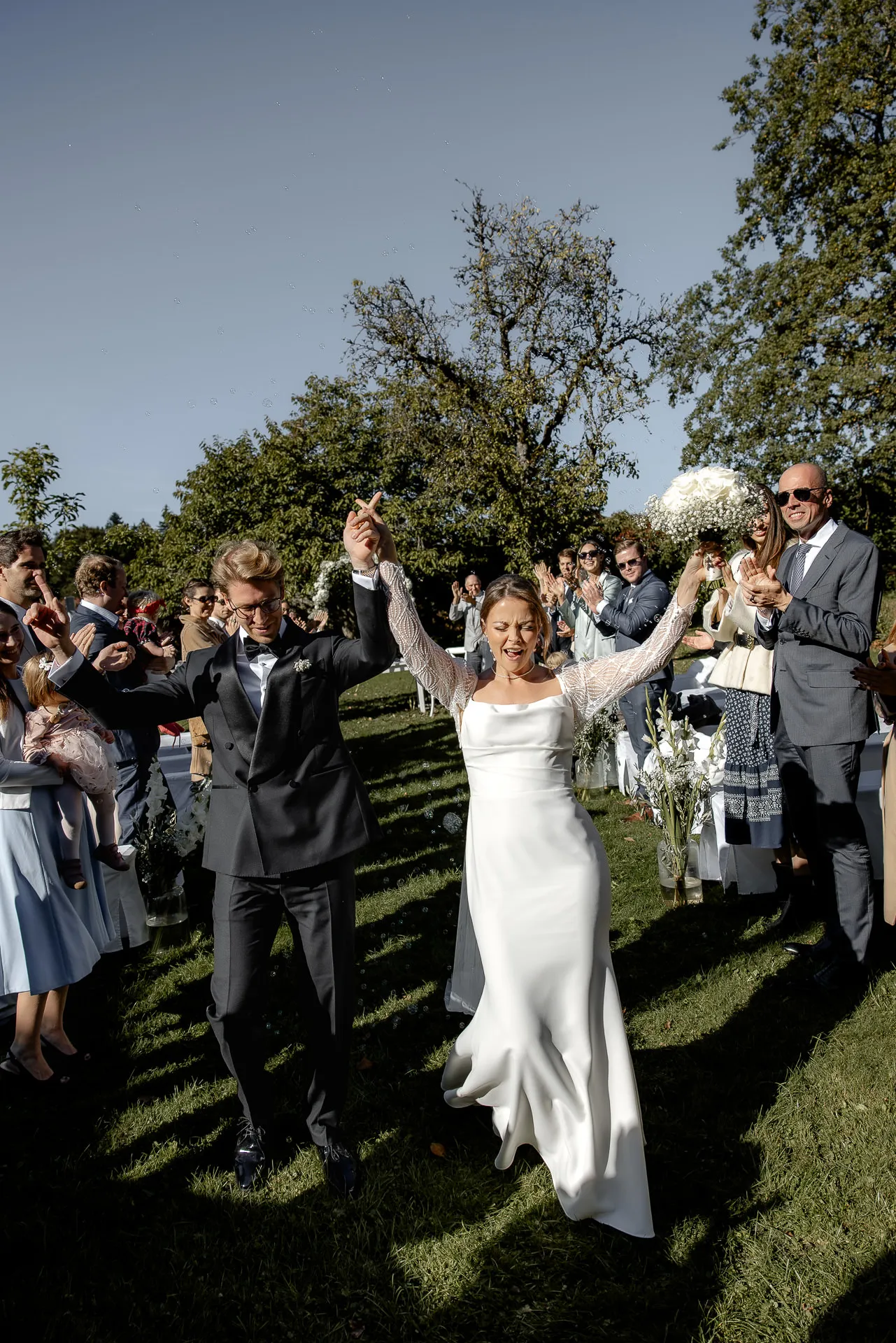 Happy bride celebrating after ceremony with guests at Gut Sonnenhausen
