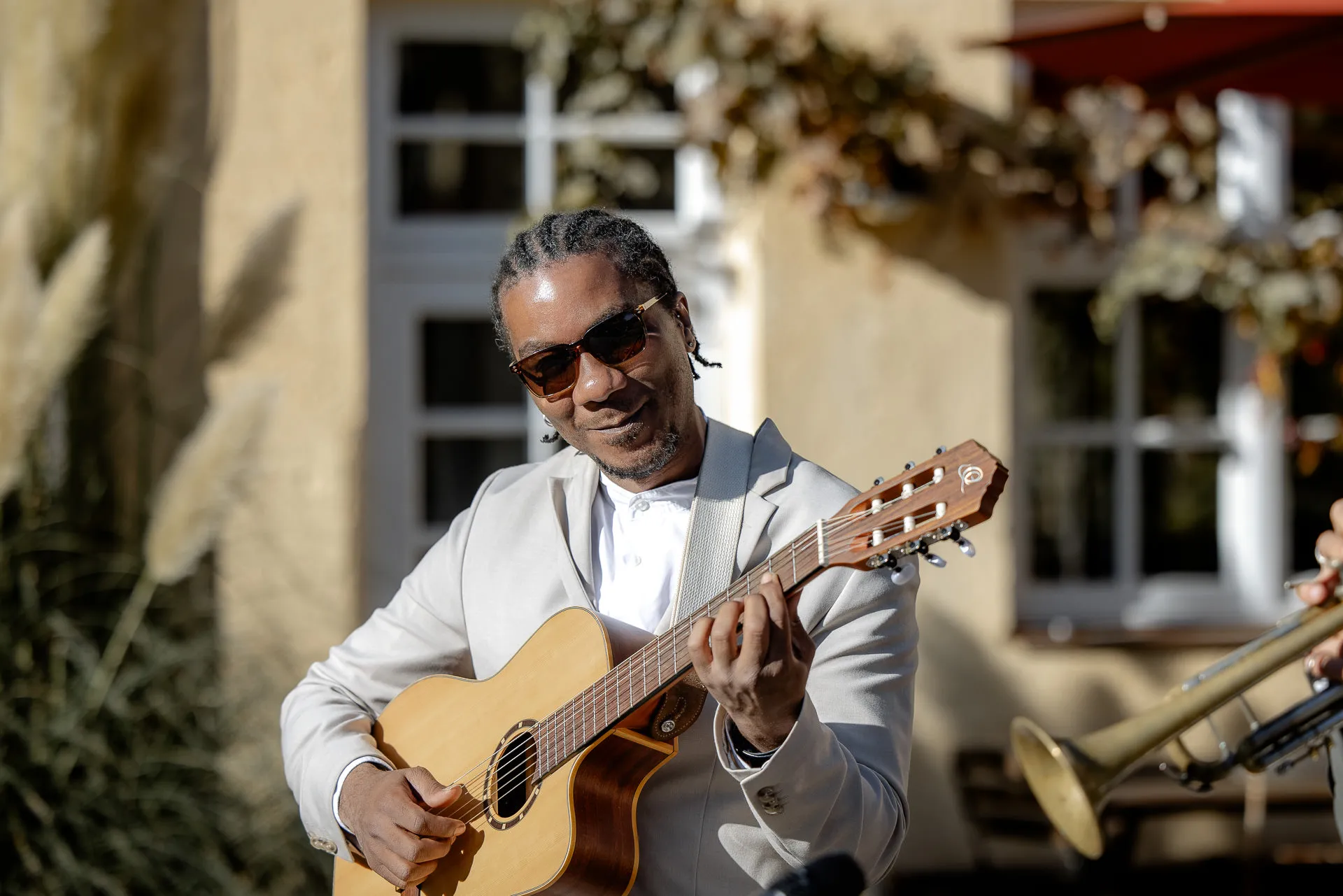 Live musician playing guitar at wedding celebration at Gut Sonnenhausen country wedding