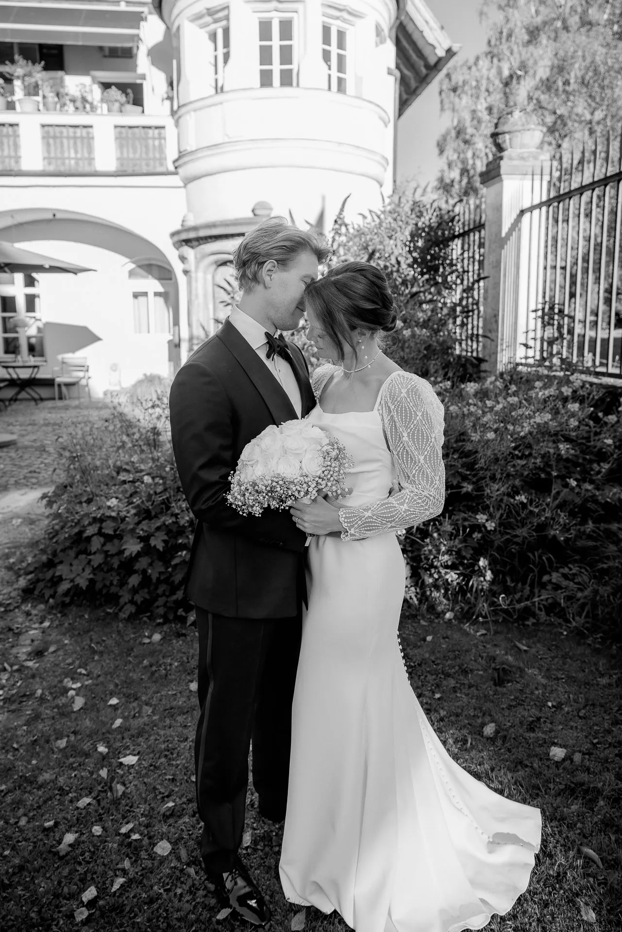 Bride and groom embracing intimately at country wedding at Gut Sonnenhausen in black and white