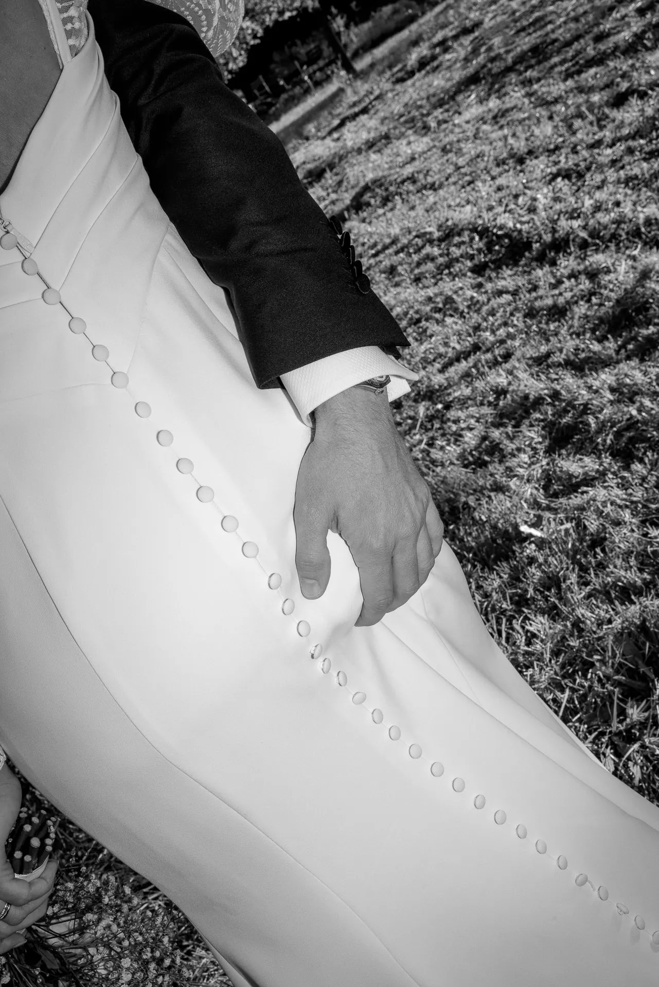 Intimate moment bride and groom with button detail on wedding dress at Gut Sonnenhausen in black and white