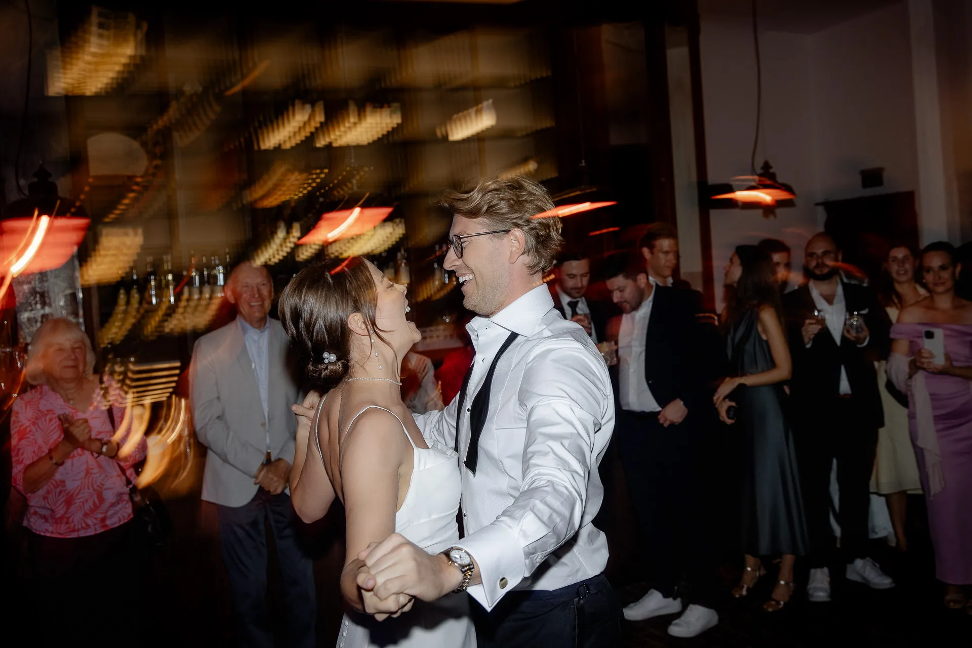 Bride and groom dancing joyfully at wedding celebration at Gut Sonnenhausen country wedding