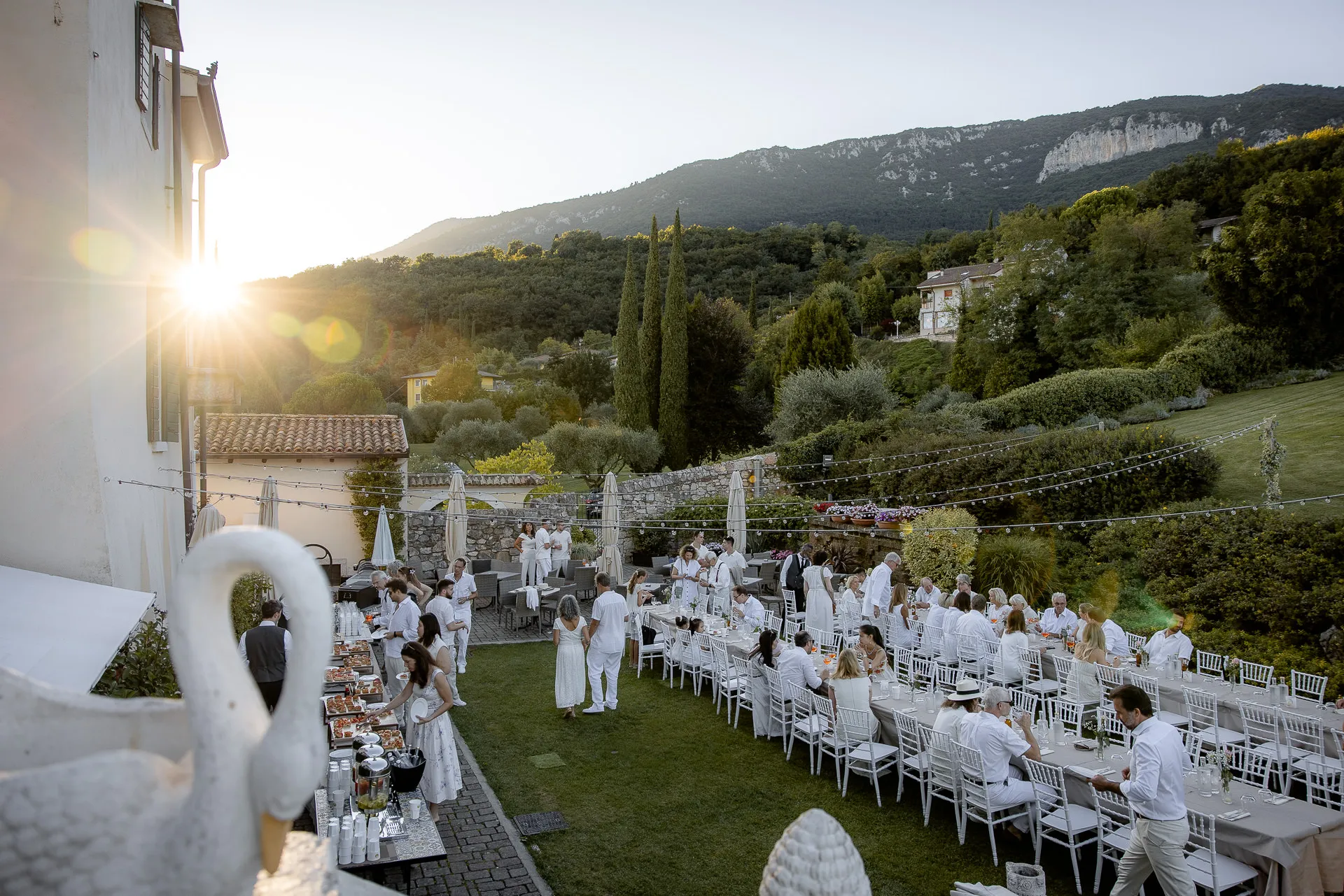 Elegant wedding celebration in white with mountain panorama at Villa Cariola