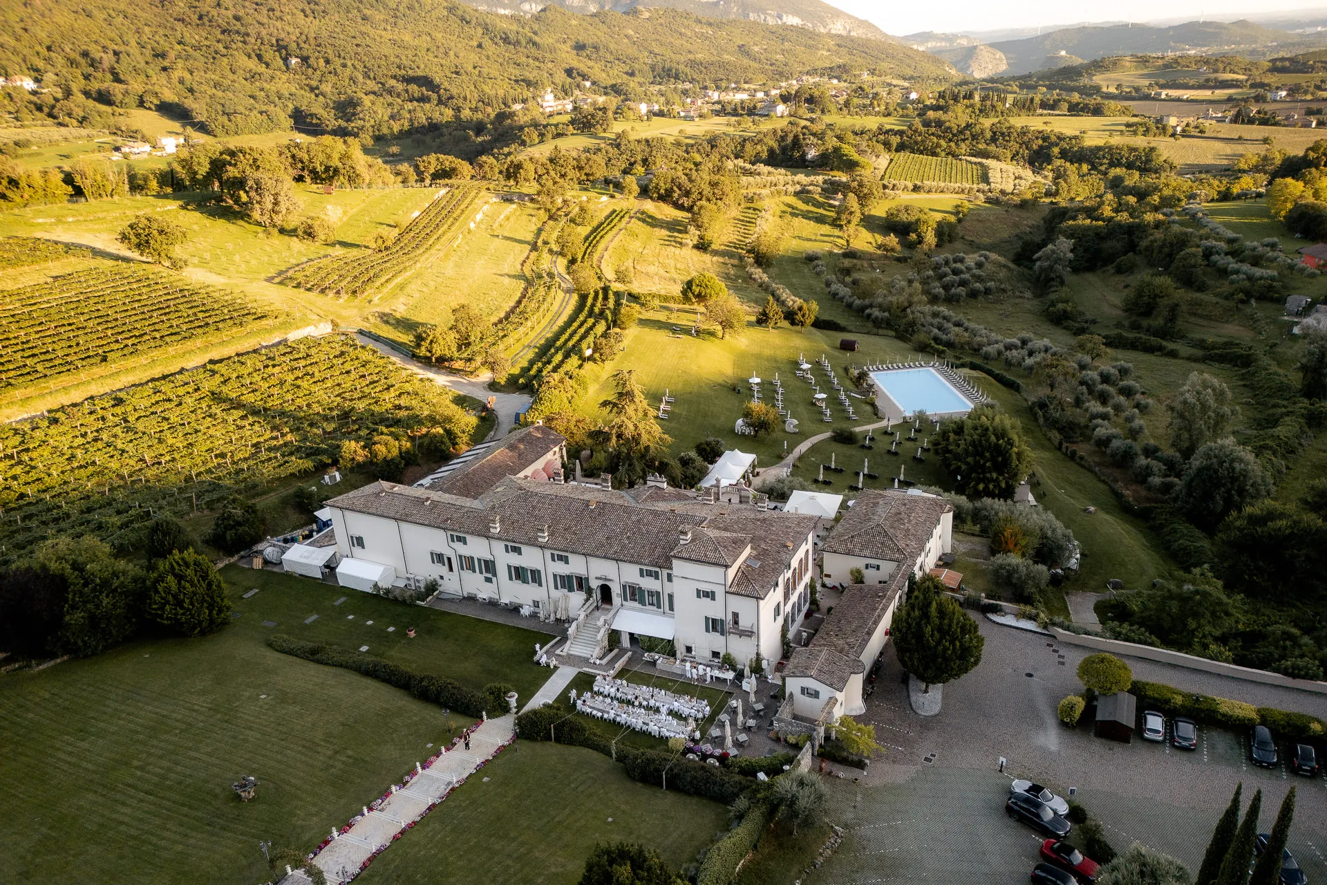 Aerial view of Villa Cariola with vineyards and wedding party at Lake Garda