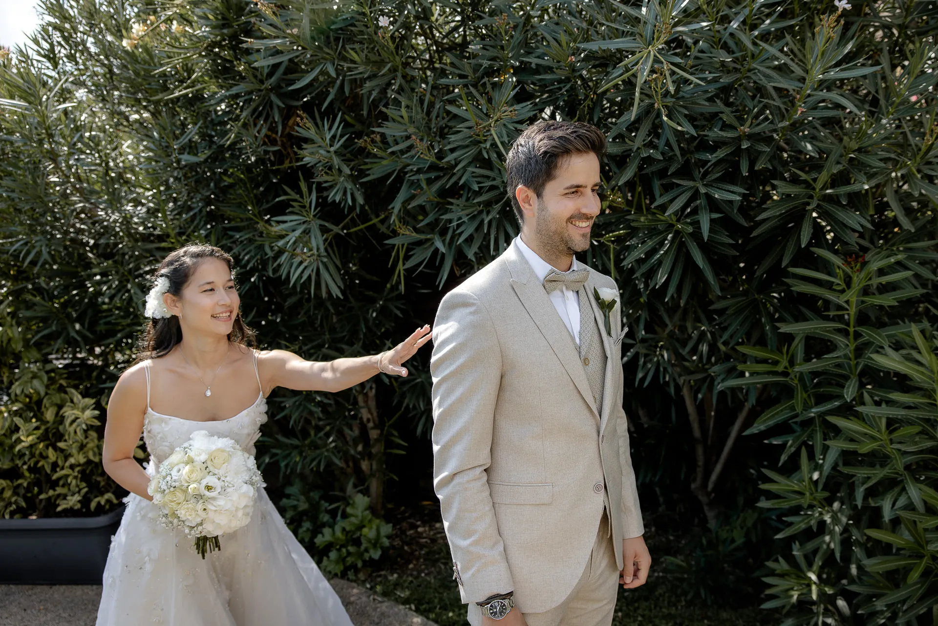 First look moment of wedding couple with bridal bouquet at Villa Cariola